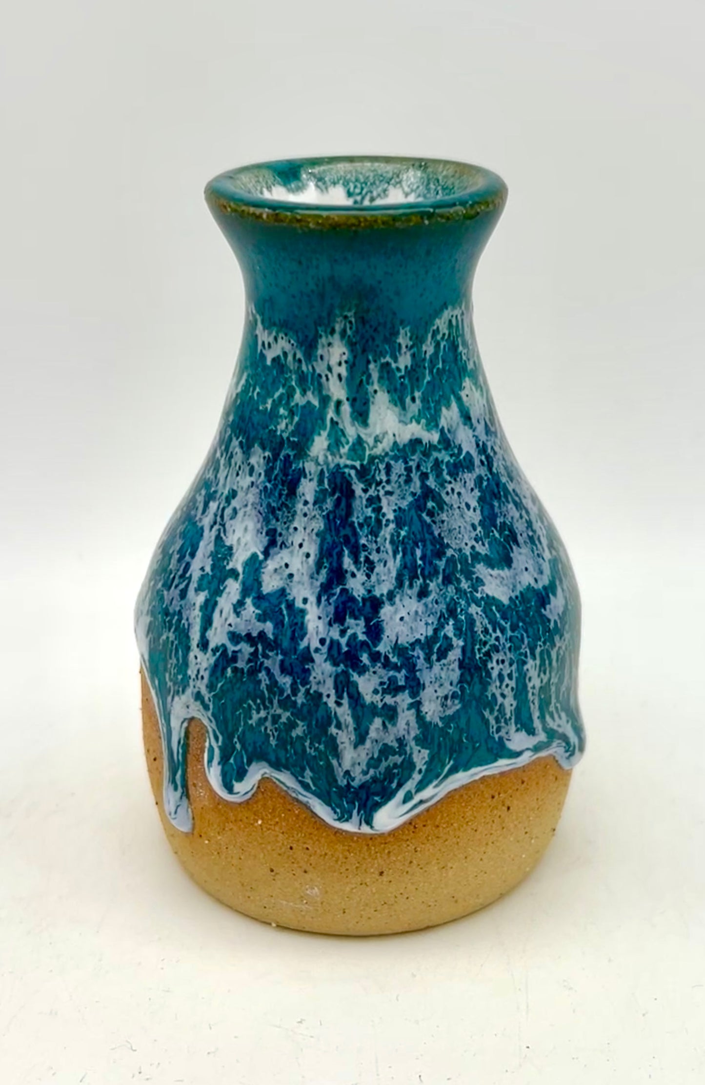 Bud vase in snowy jade on toasty clay