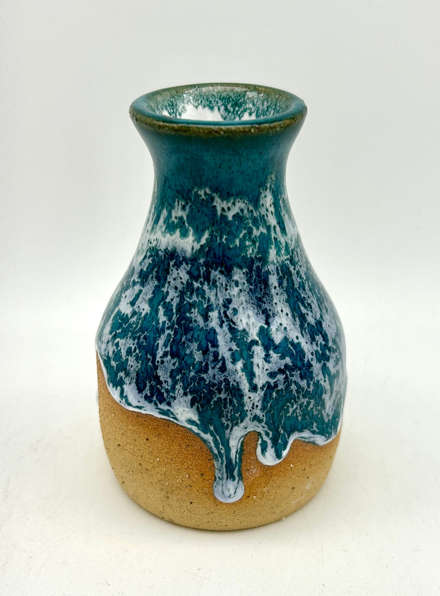 Bud vase in snowy jade on toasty clay