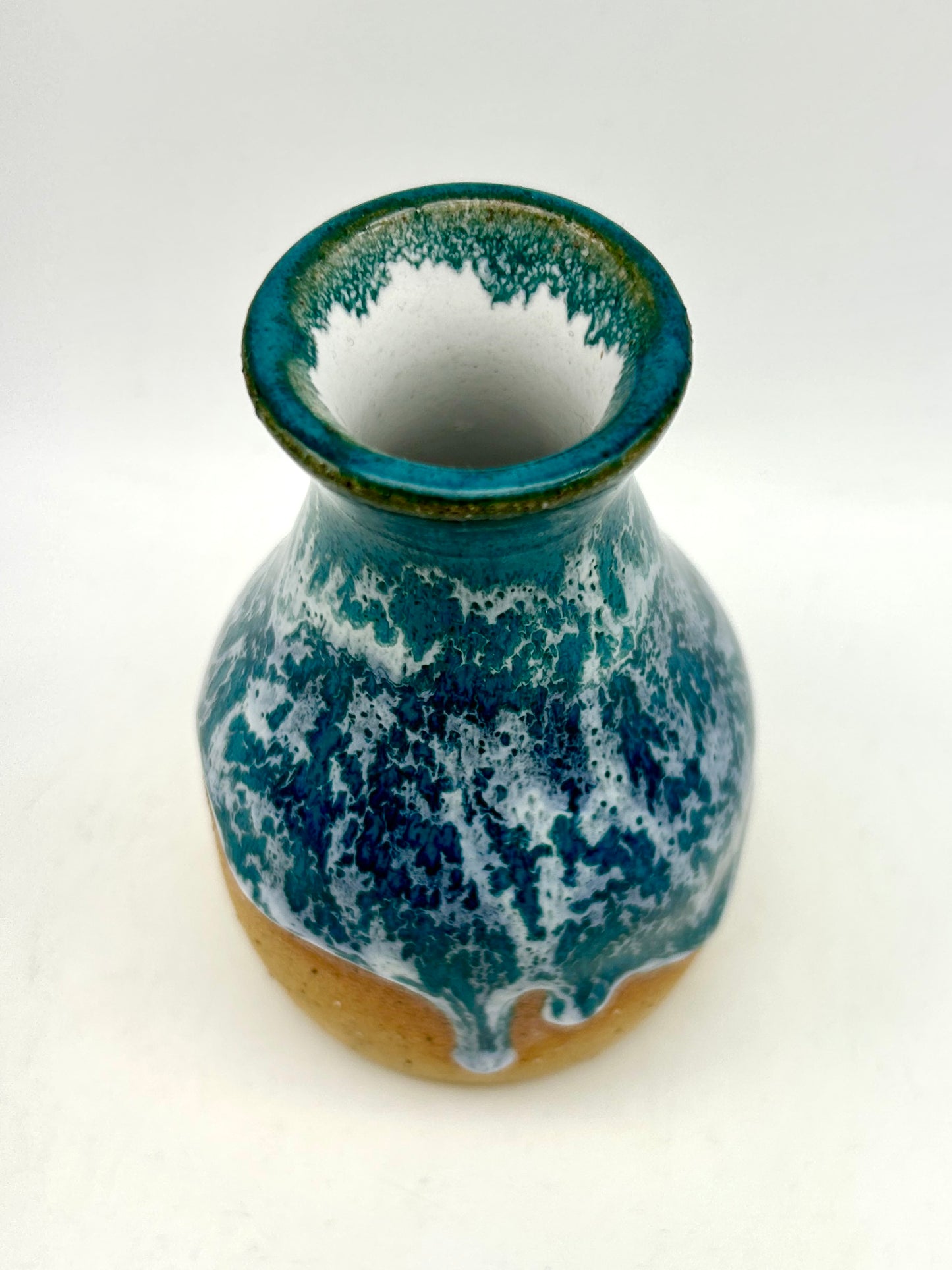 Bud vase in snowy jade on toasty clay