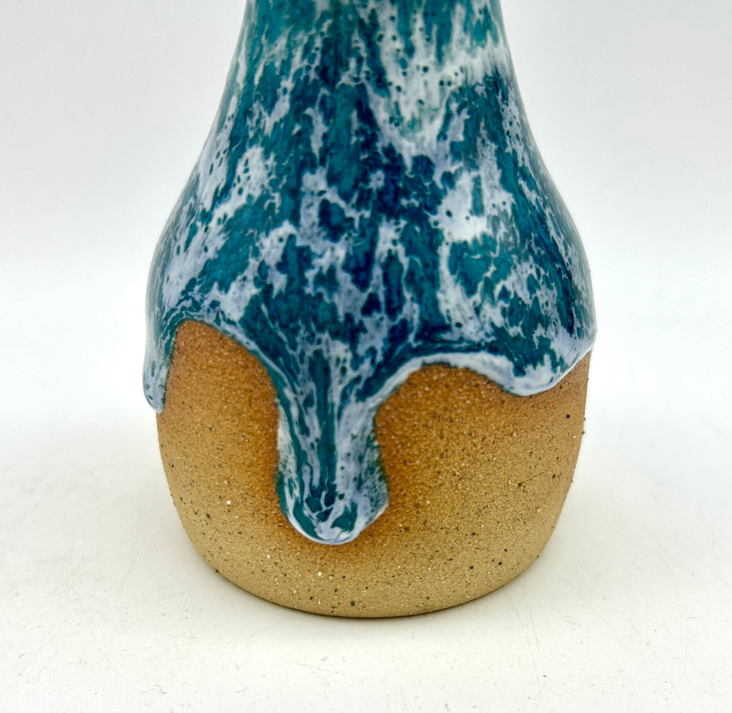 Bud vase in snowy jade on toasty clay