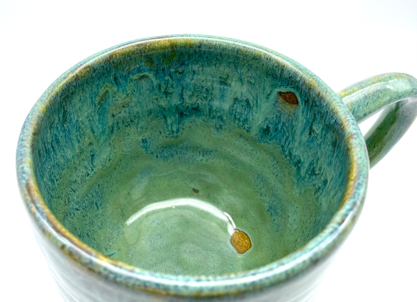 Mug in lush dripping greens
