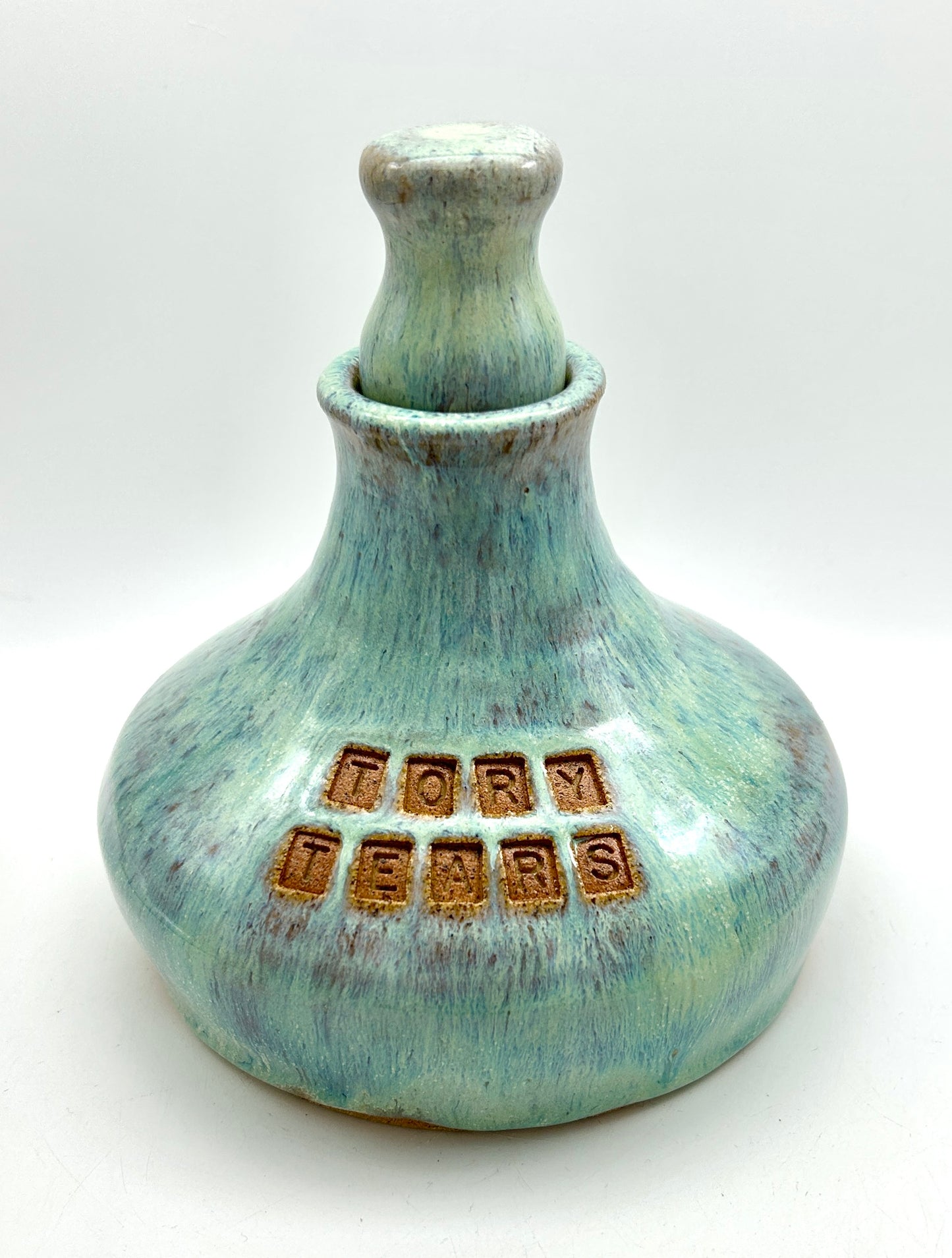 'Tory tears' decanter in toasty clay and green glazes