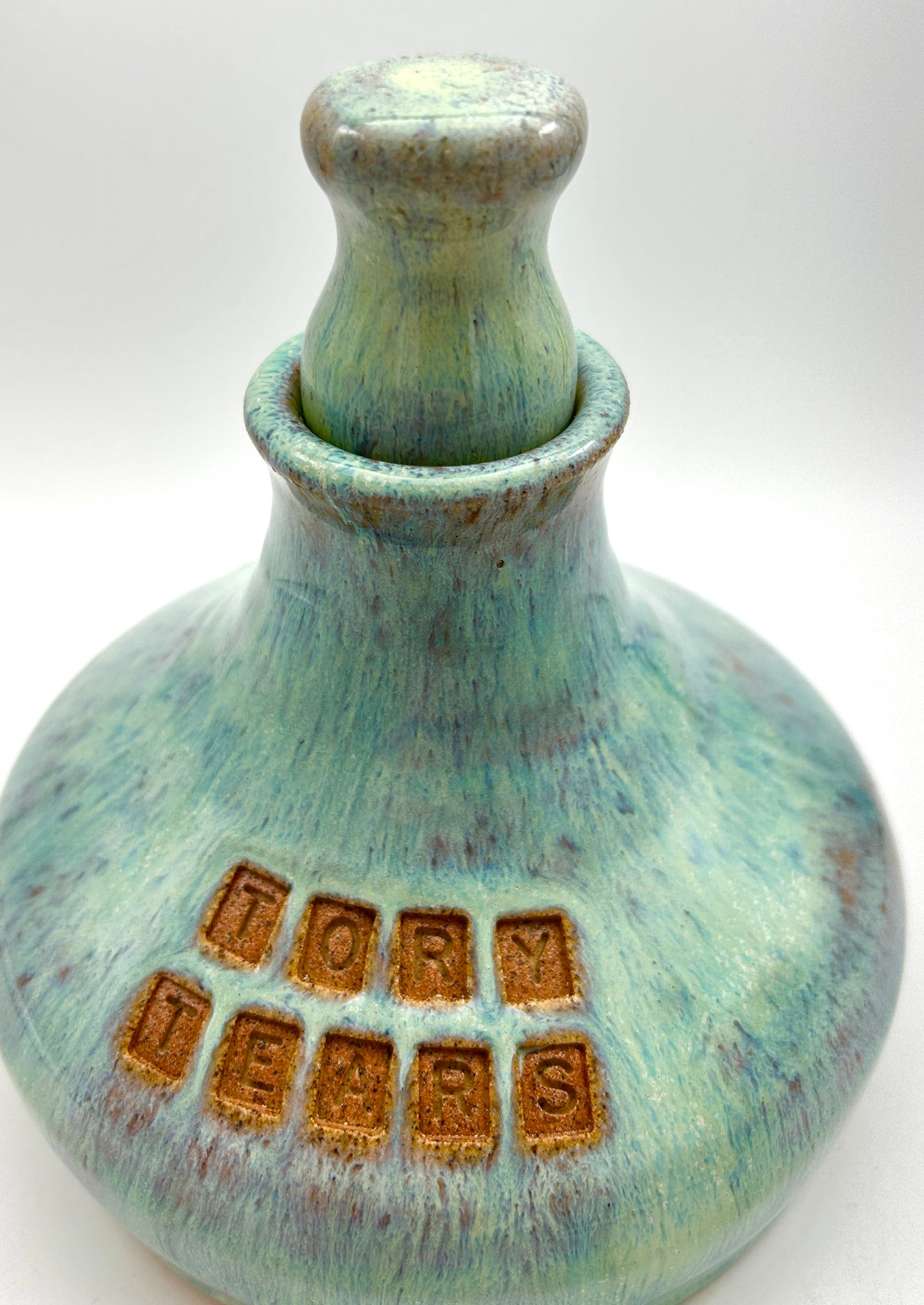'Tory tears' decanter in toasty clay and green glazes