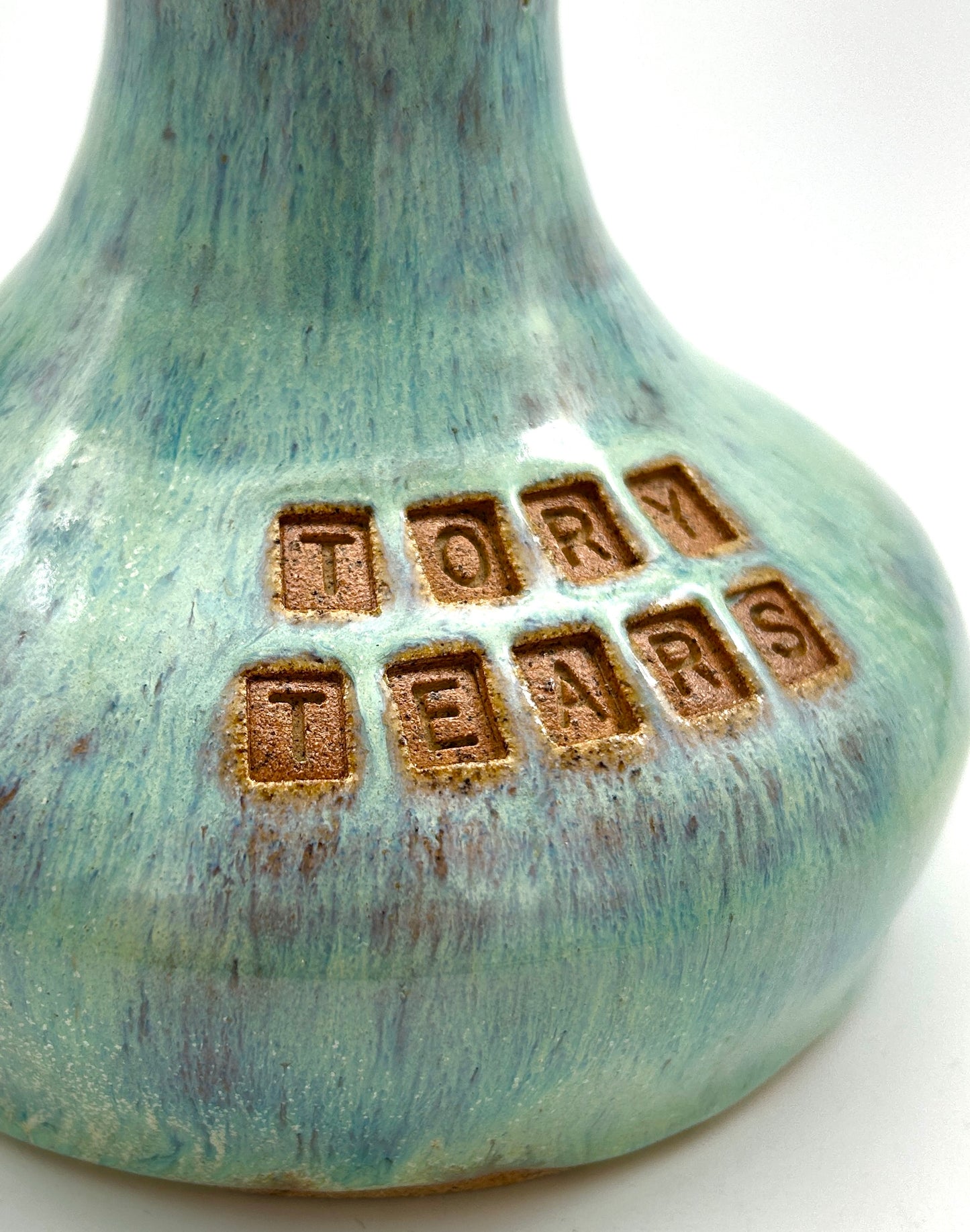 'Tory tears' decanter in toasty clay and green glazes