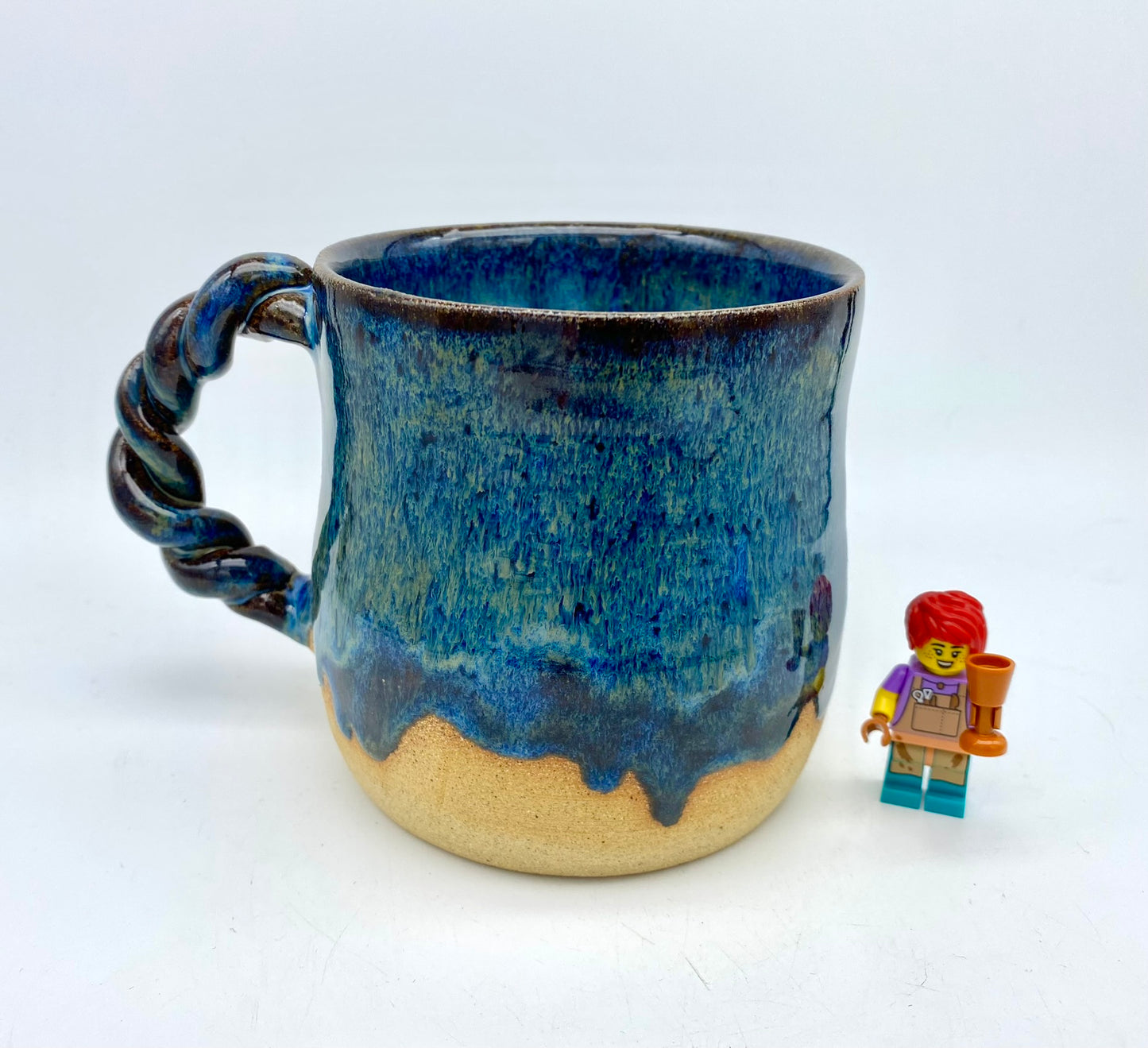 Mug in toasty clay with rich blue glazes