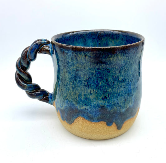 Mug in toasty clay with rich blue glazes