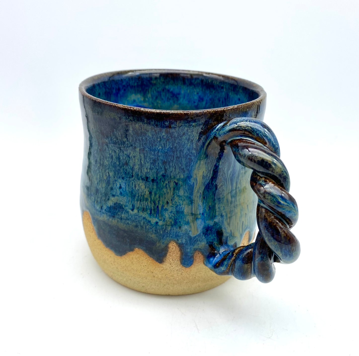 Mug in toasty clay with rich blue glazes