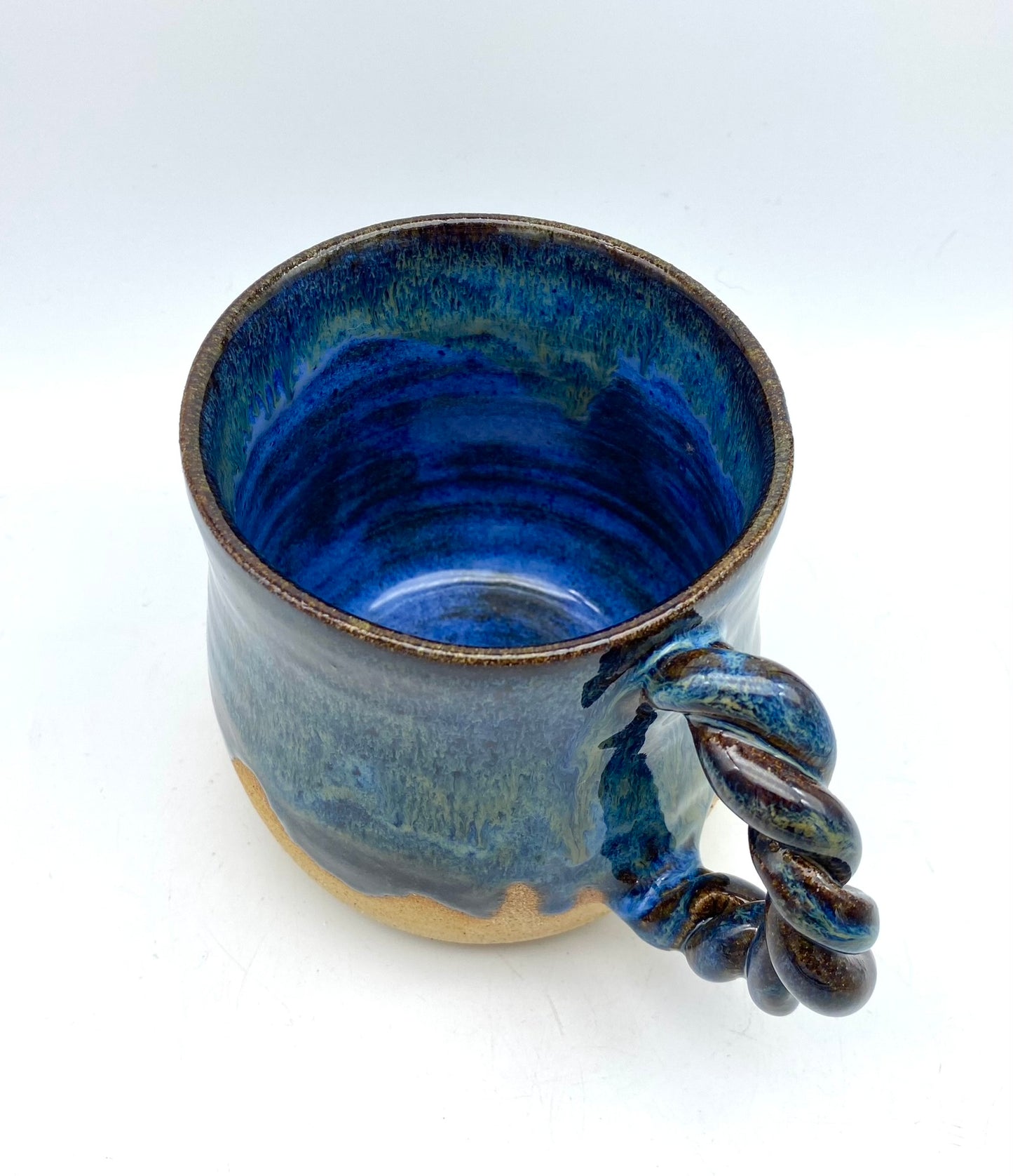 Mug in toasty clay with rich blue glazes