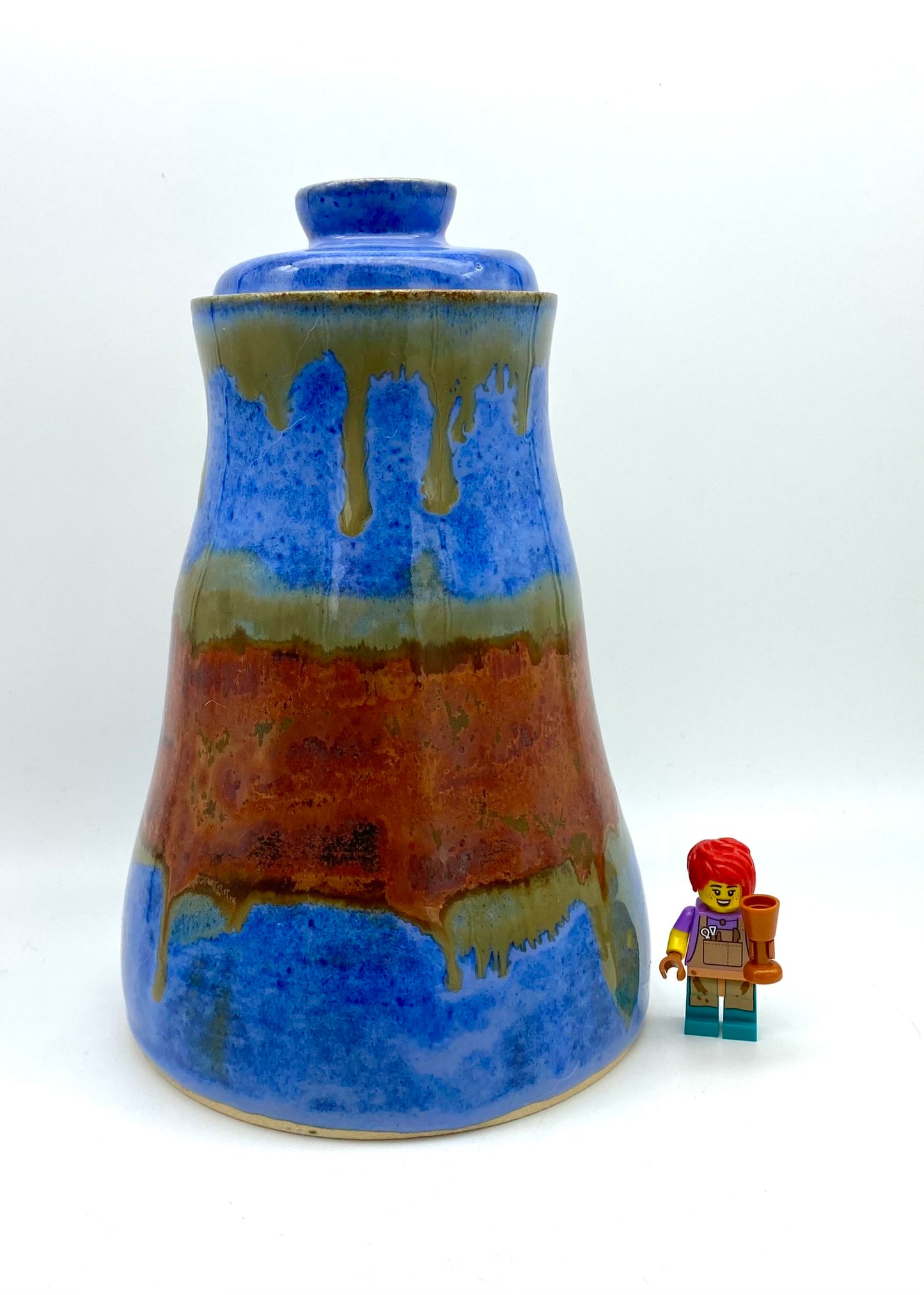 SECOND Tall lidded pot in bright blues with copper bands