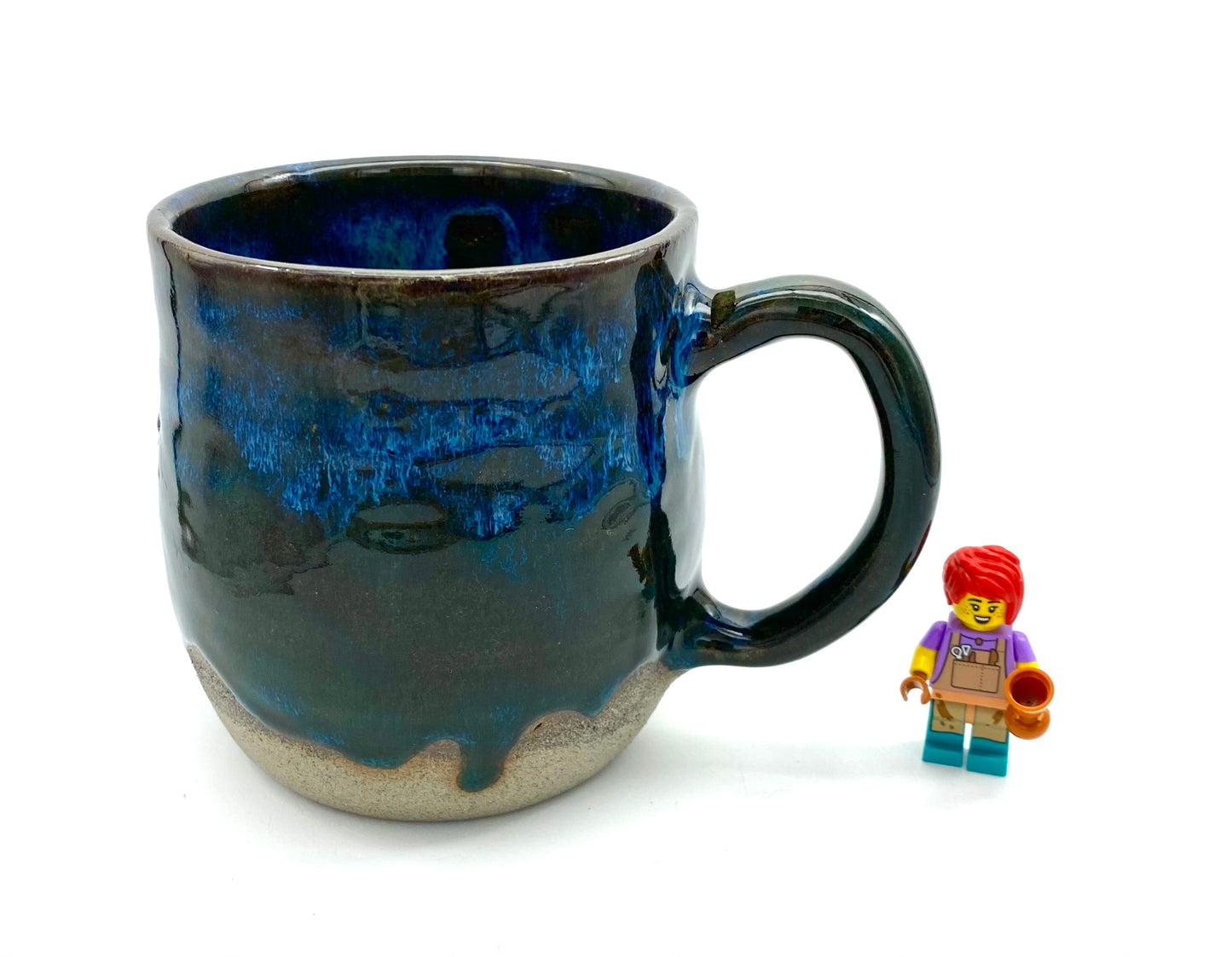 Mug in rich dark glazes with drips of blue