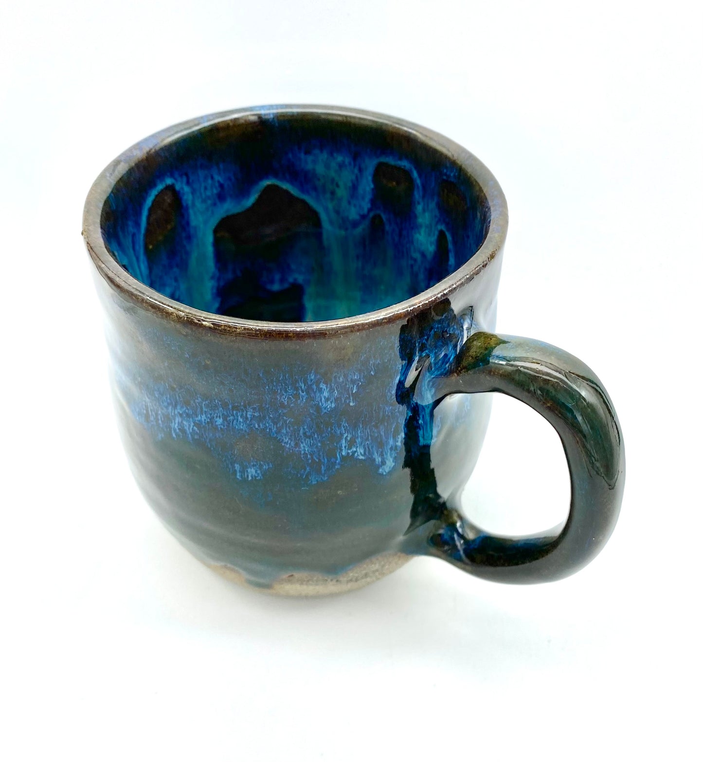 Mug in rich dark glazes with drips of blue