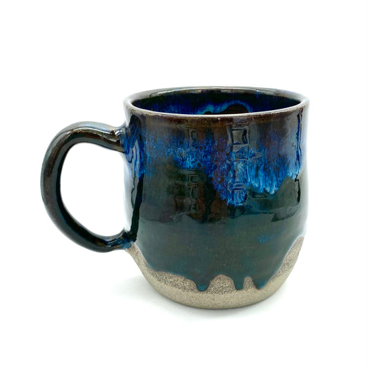 Mug in rich dark glazes with drips of blue