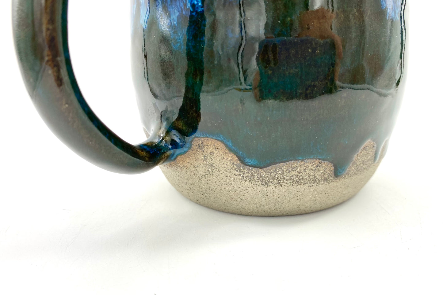 Mug in rich dark glazes with drips of blue