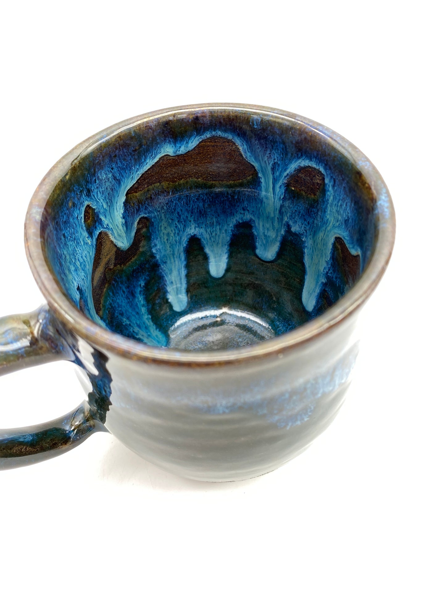 Mug in rich dark glazes with drips of blue