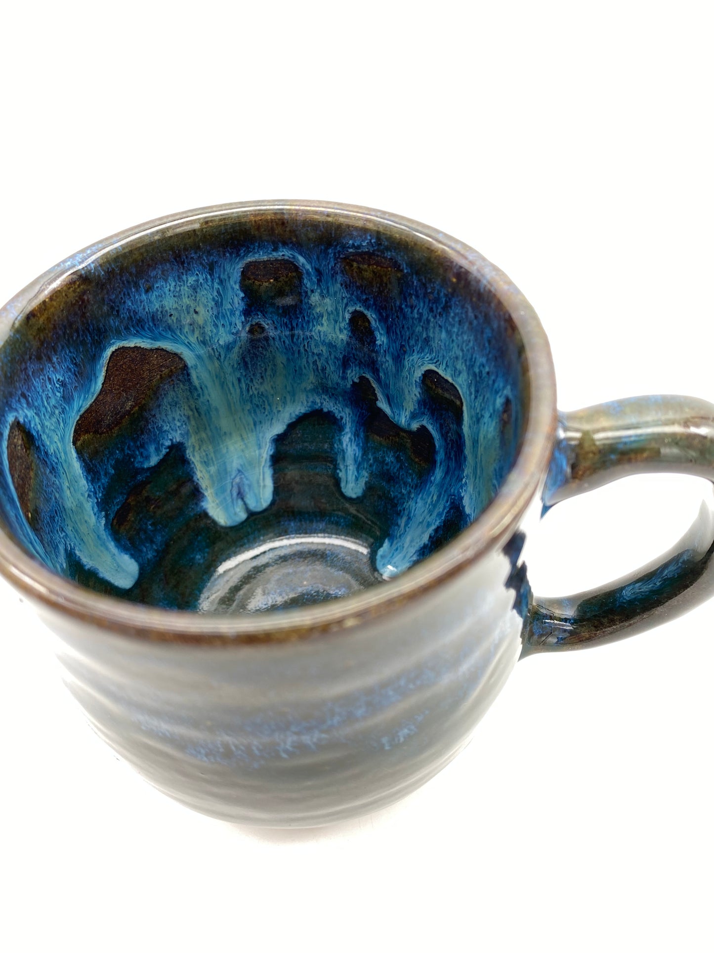 Mug in rich dark glazes with drips of blue