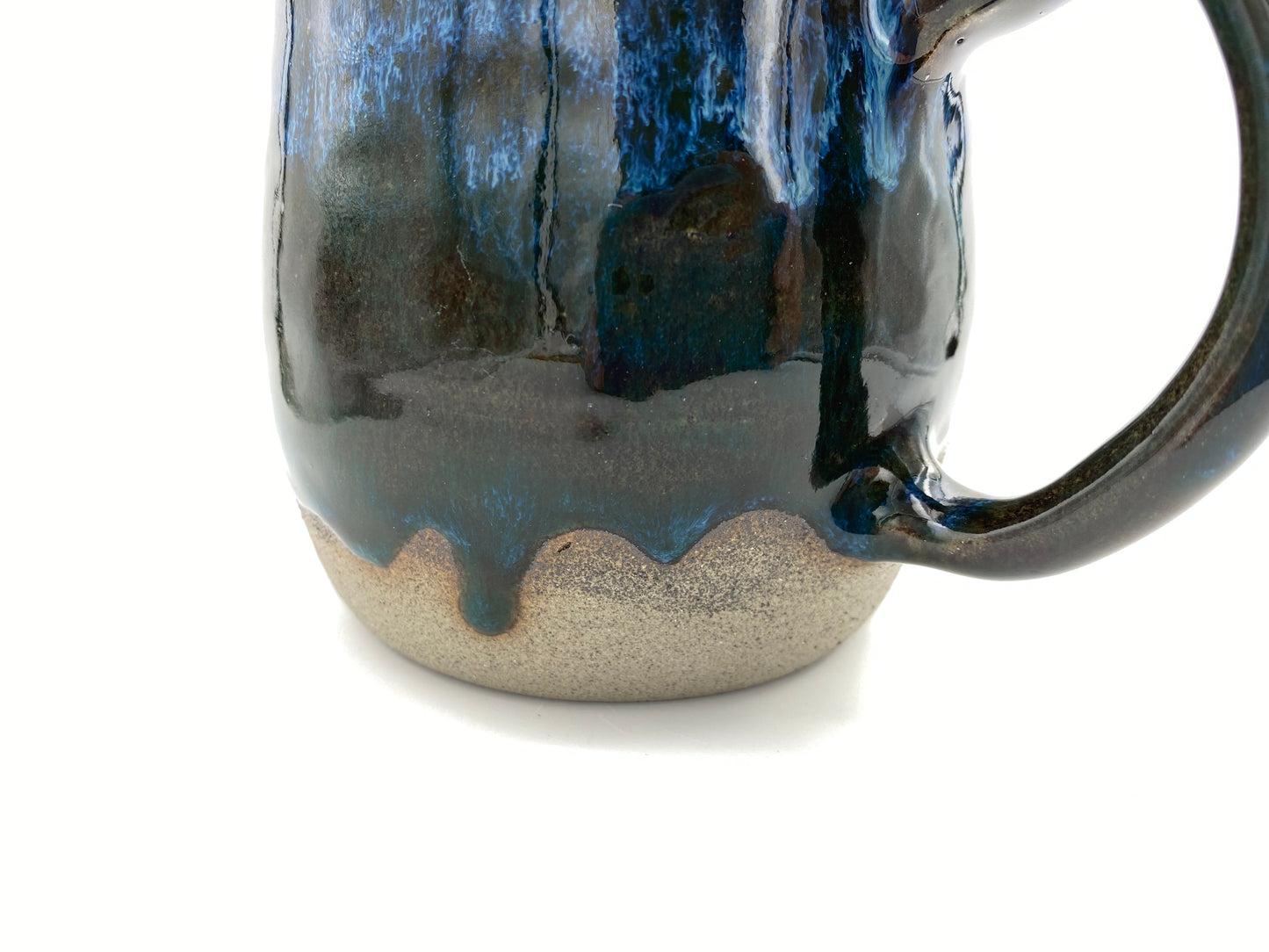 Mug in rich dark glazes with drips of blue