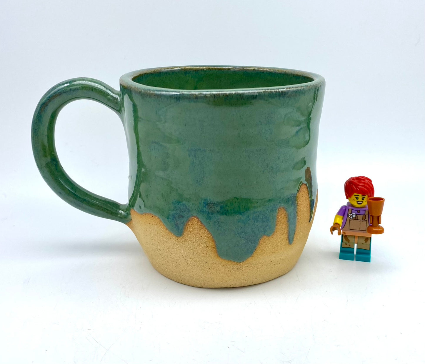 Mug in toasty clay glazed with flowing greens