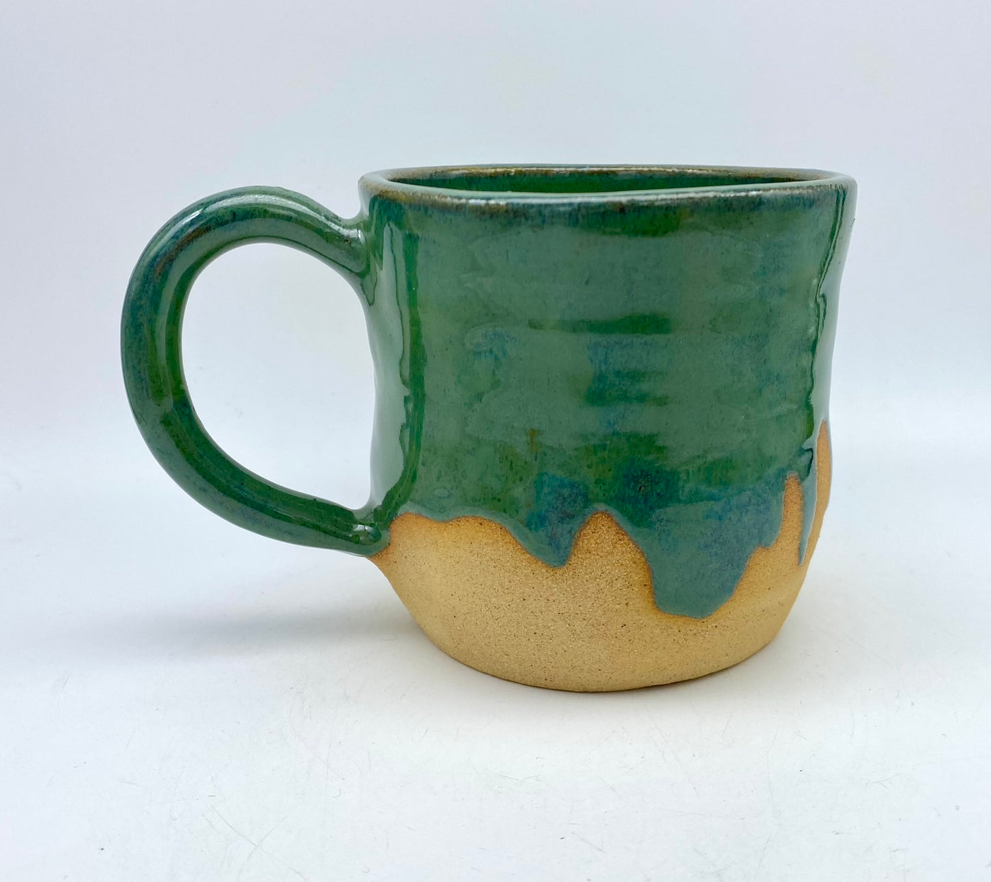 Mug in toasty clay glazed with flowing greens