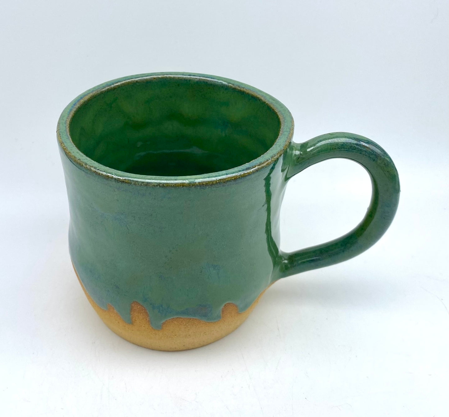 Mug in toasty clay glazed with flowing greens