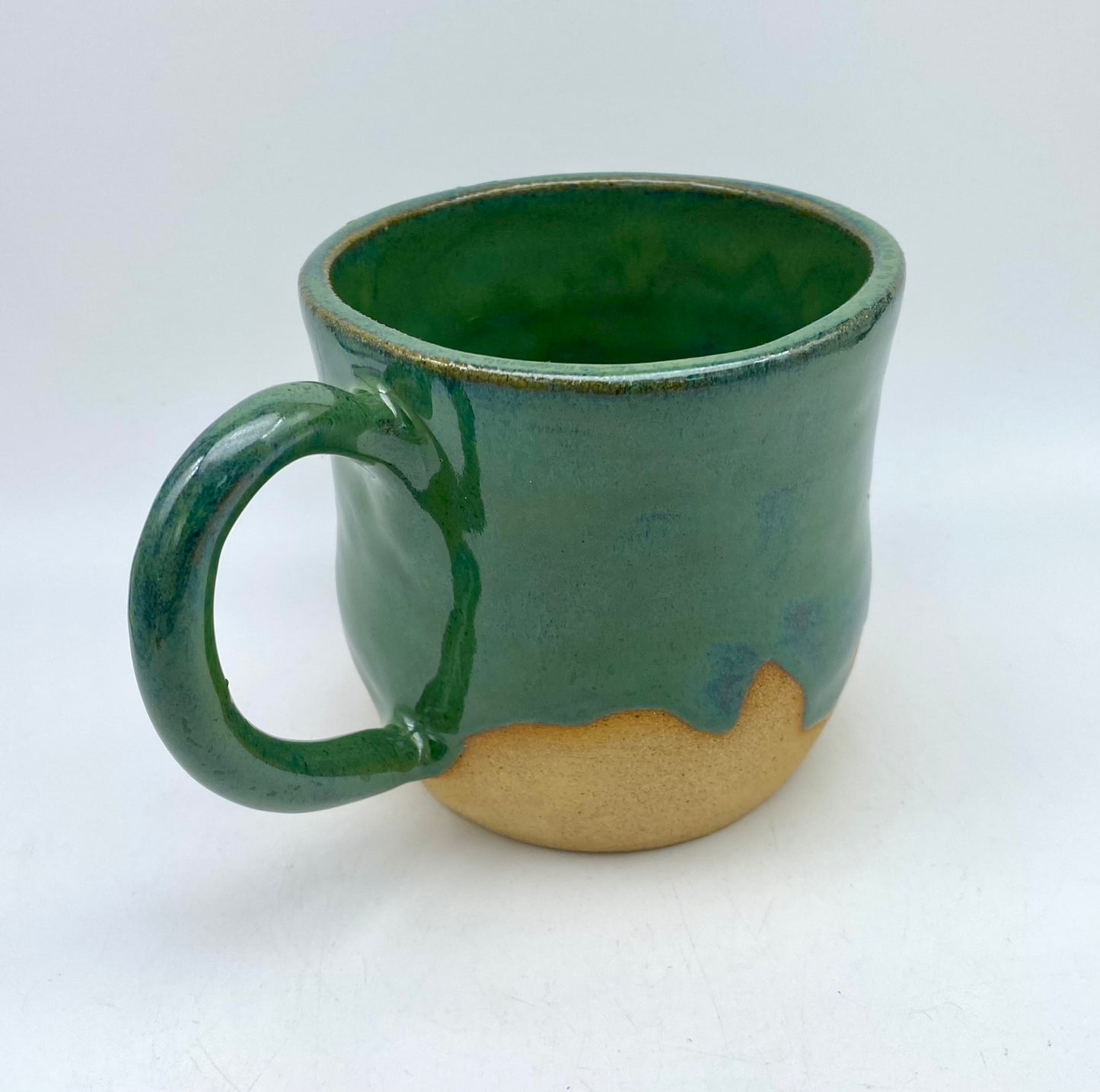 Mug in toasty clay glazed with flowing greens