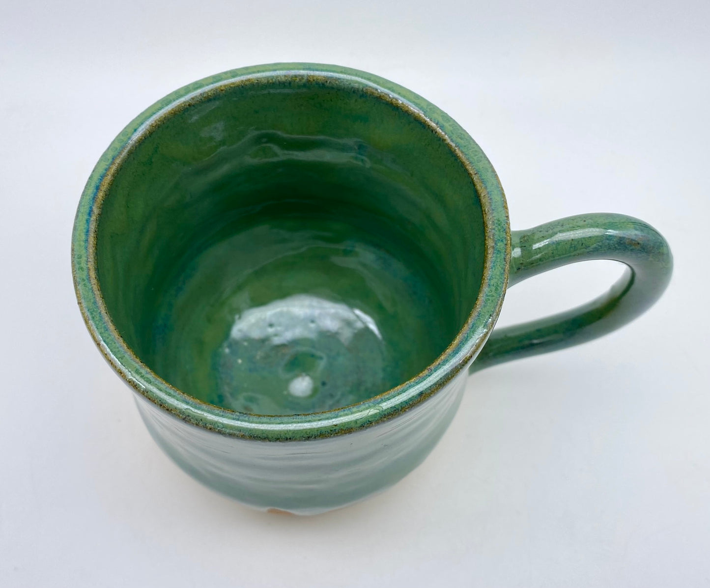 Mug in toasty clay glazed with flowing greens