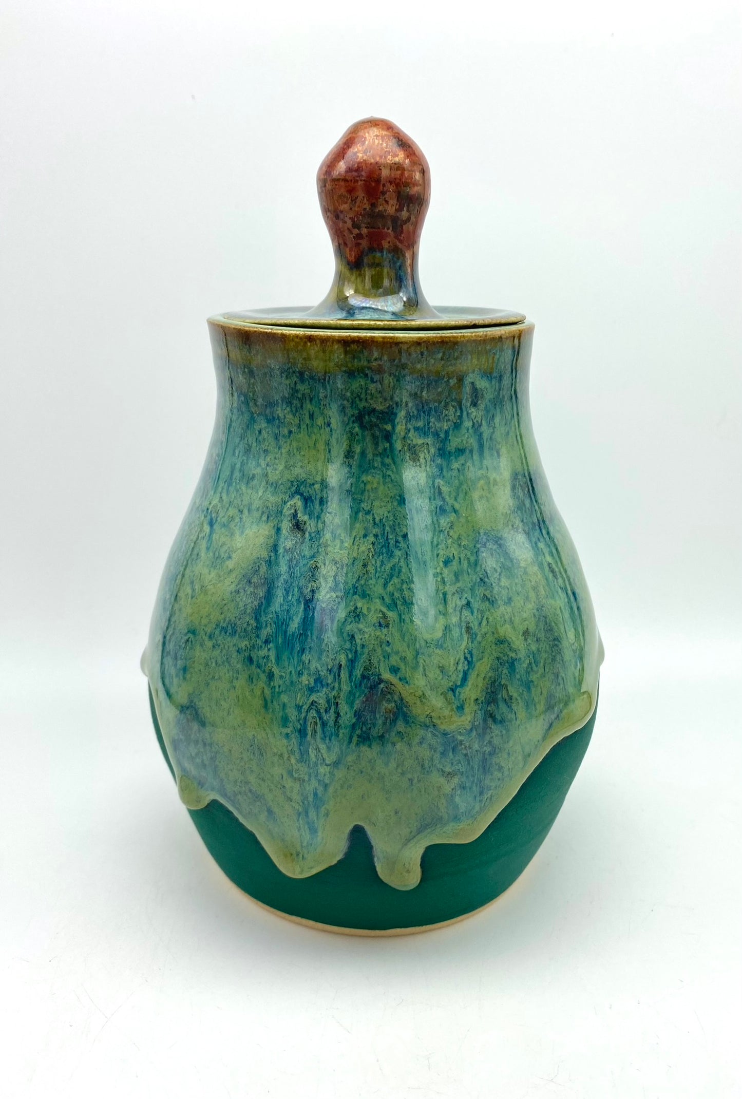 Lidded jar with stunning glaze drips and burnished copper