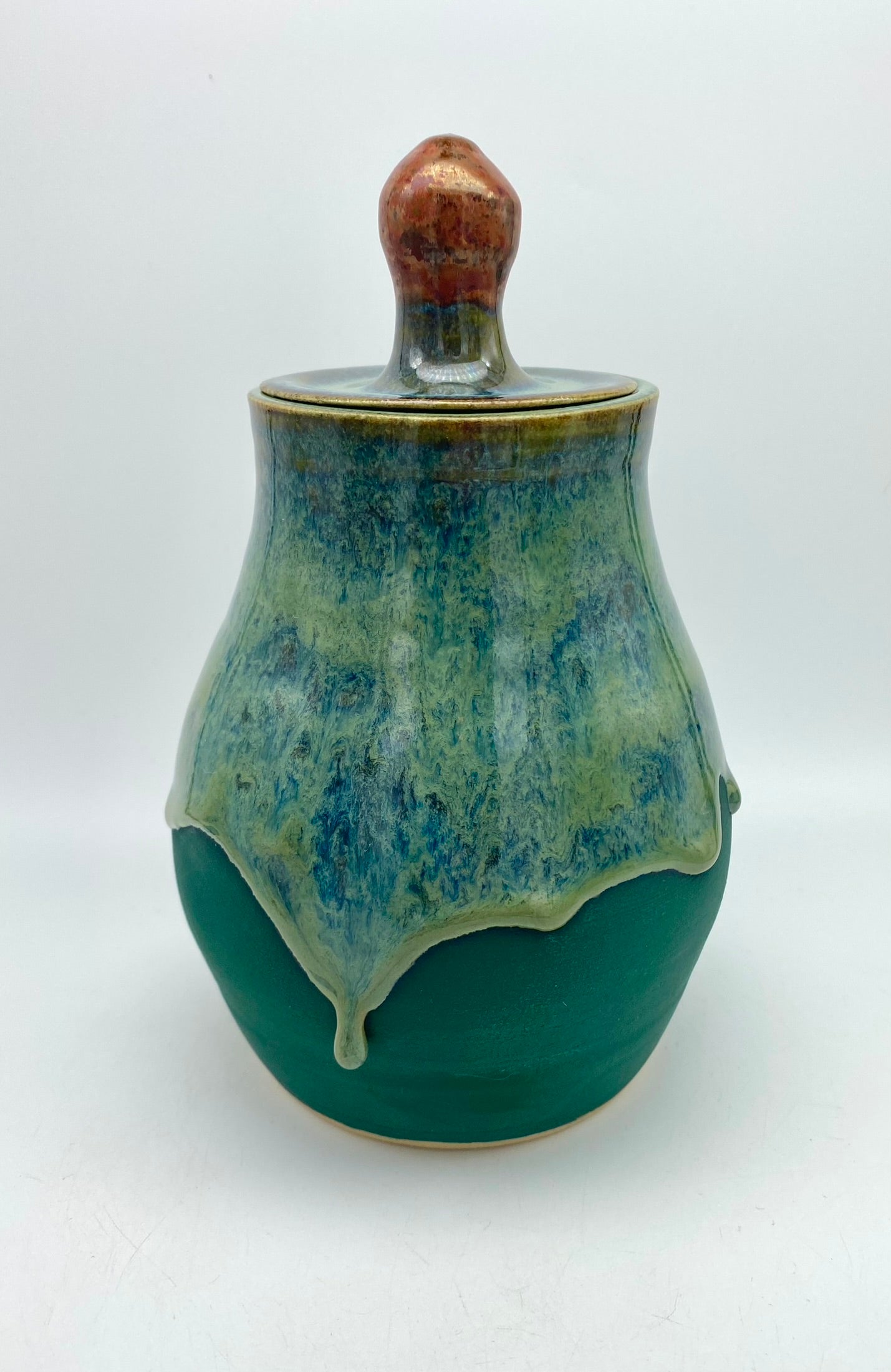 Lidded jar with stunning glaze drips and burnished copper