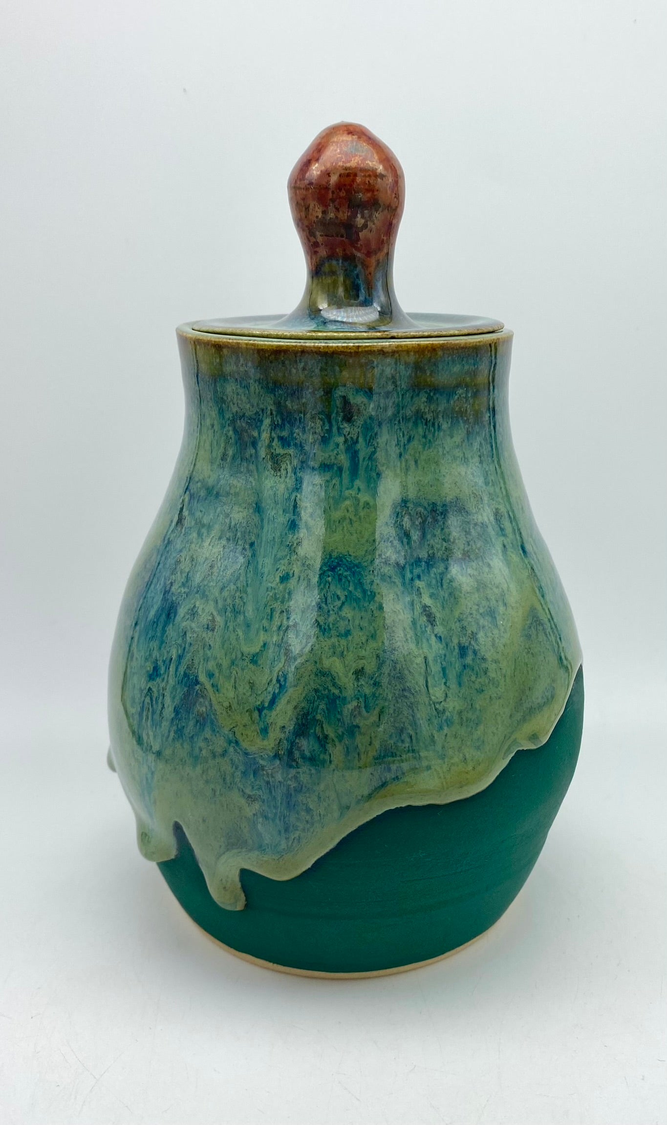 Lidded jar with stunning glaze drips and burnished copper