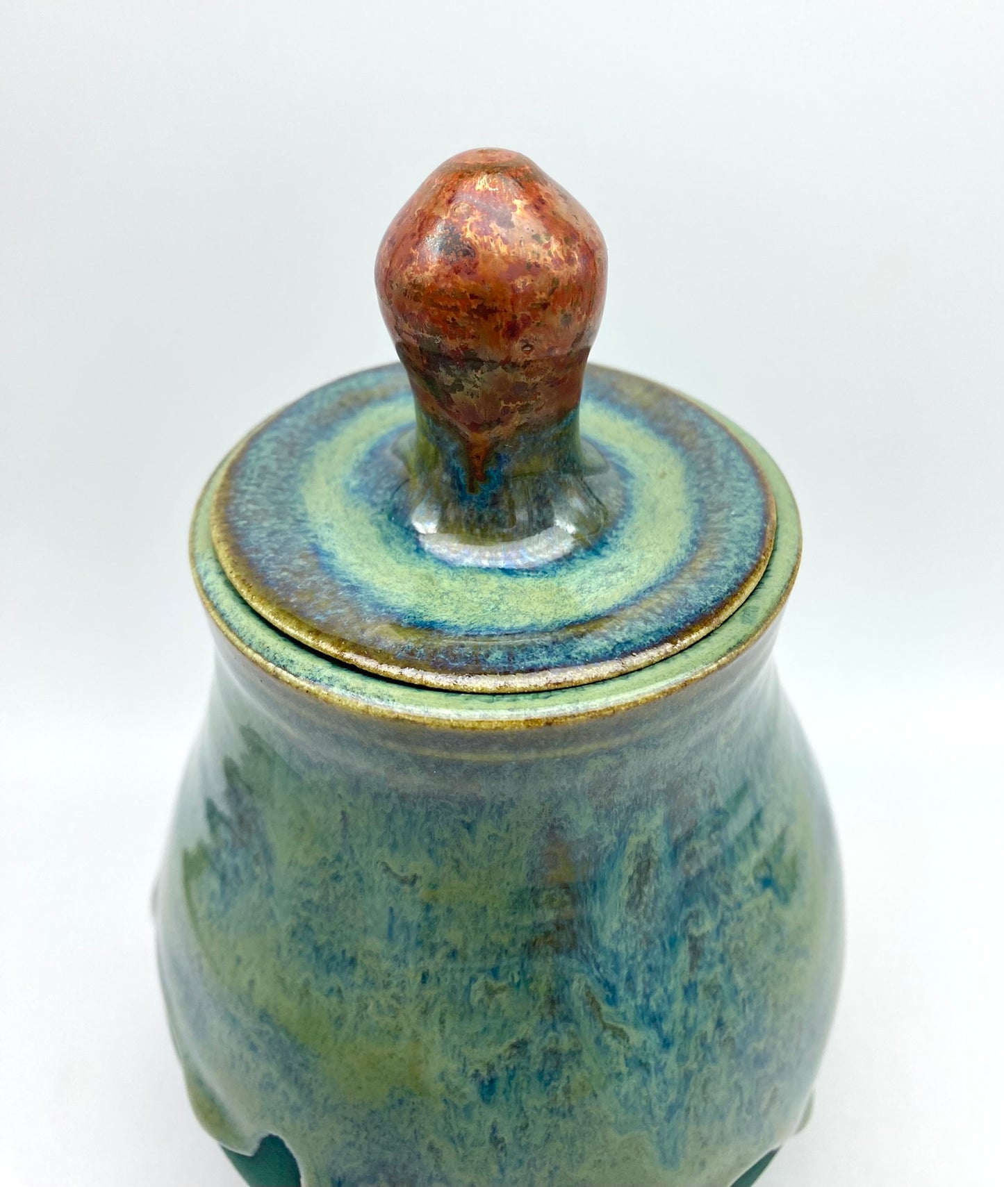 Lidded jar with stunning glaze drips and burnished copper