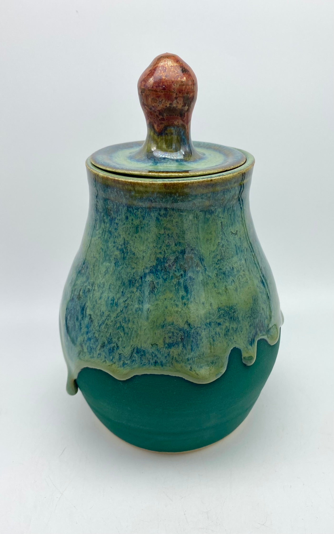 Lidded jar with stunning glaze drips and burnished copper