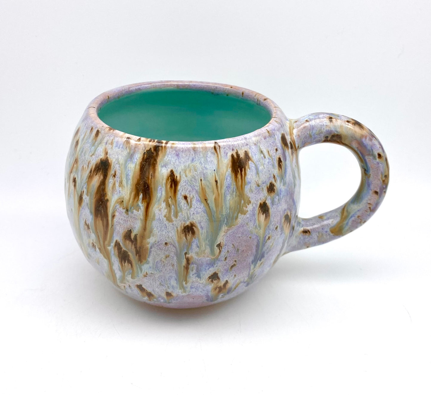 Cute round mug in turquoise and lilacs