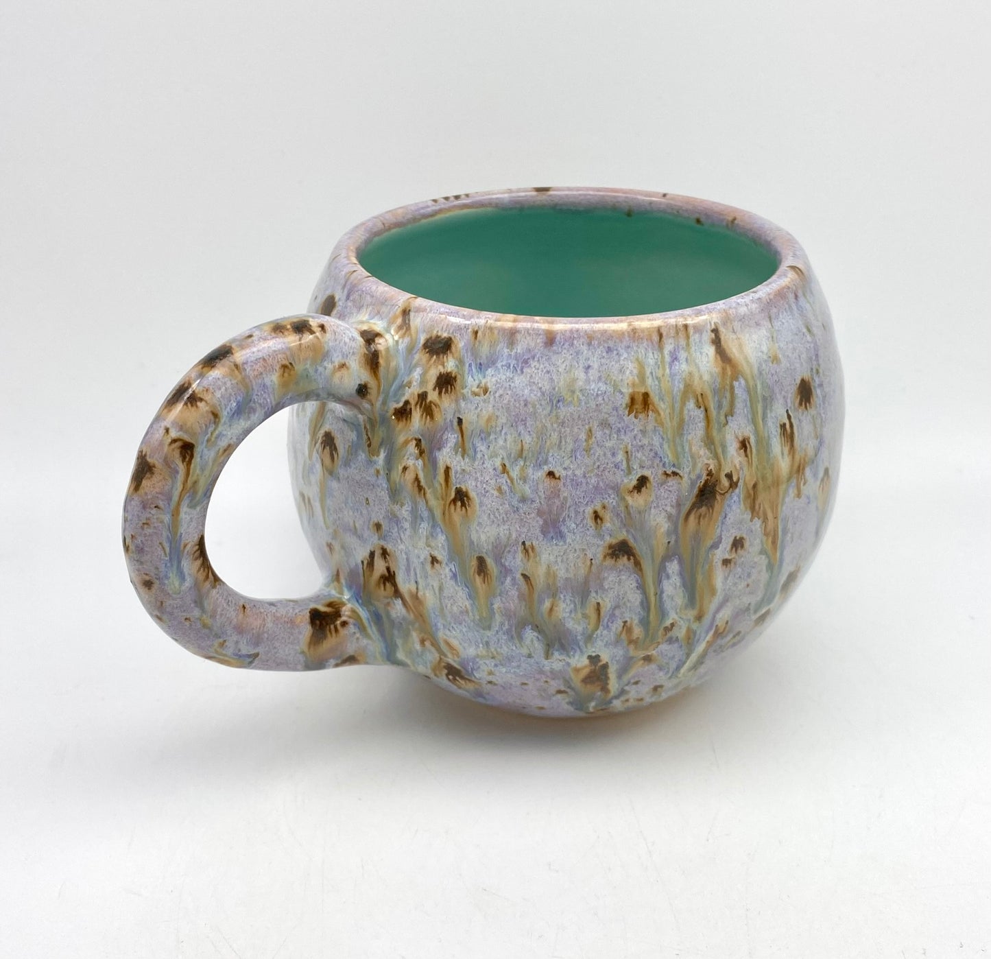 Cute round mug in turquoise and lilacs