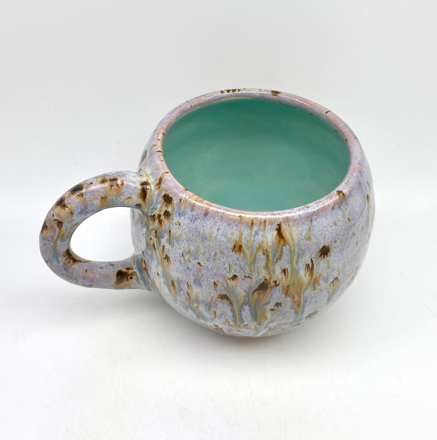 Cute round mug in turquoise and lilacs