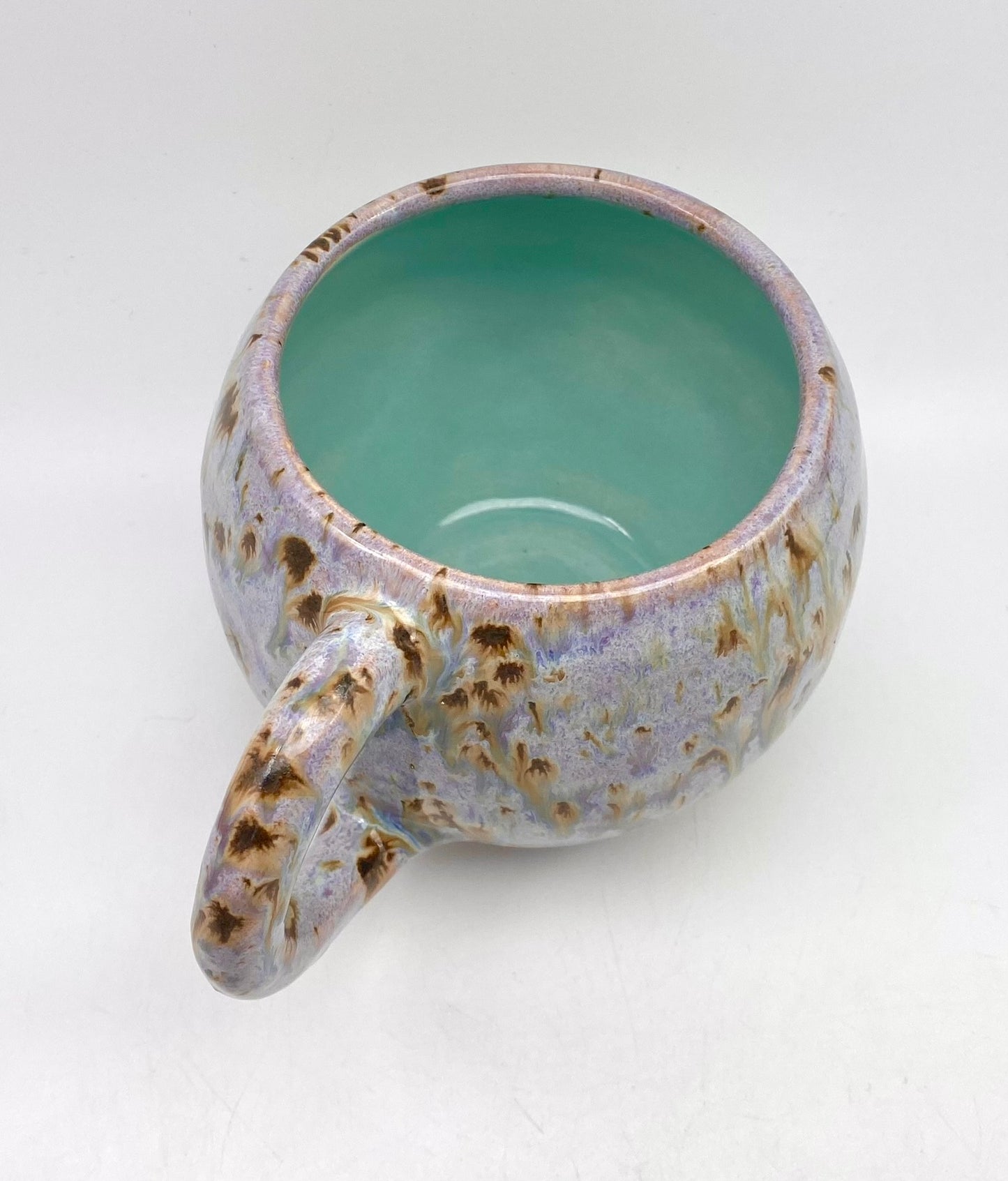 Cute round mug in turquoise and lilacs