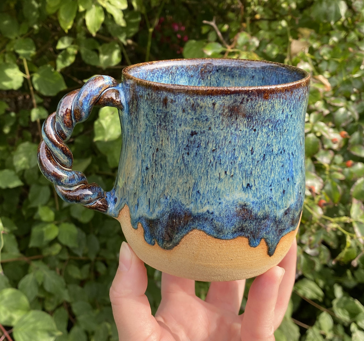 Mug in toasty clay with rich blue glazes