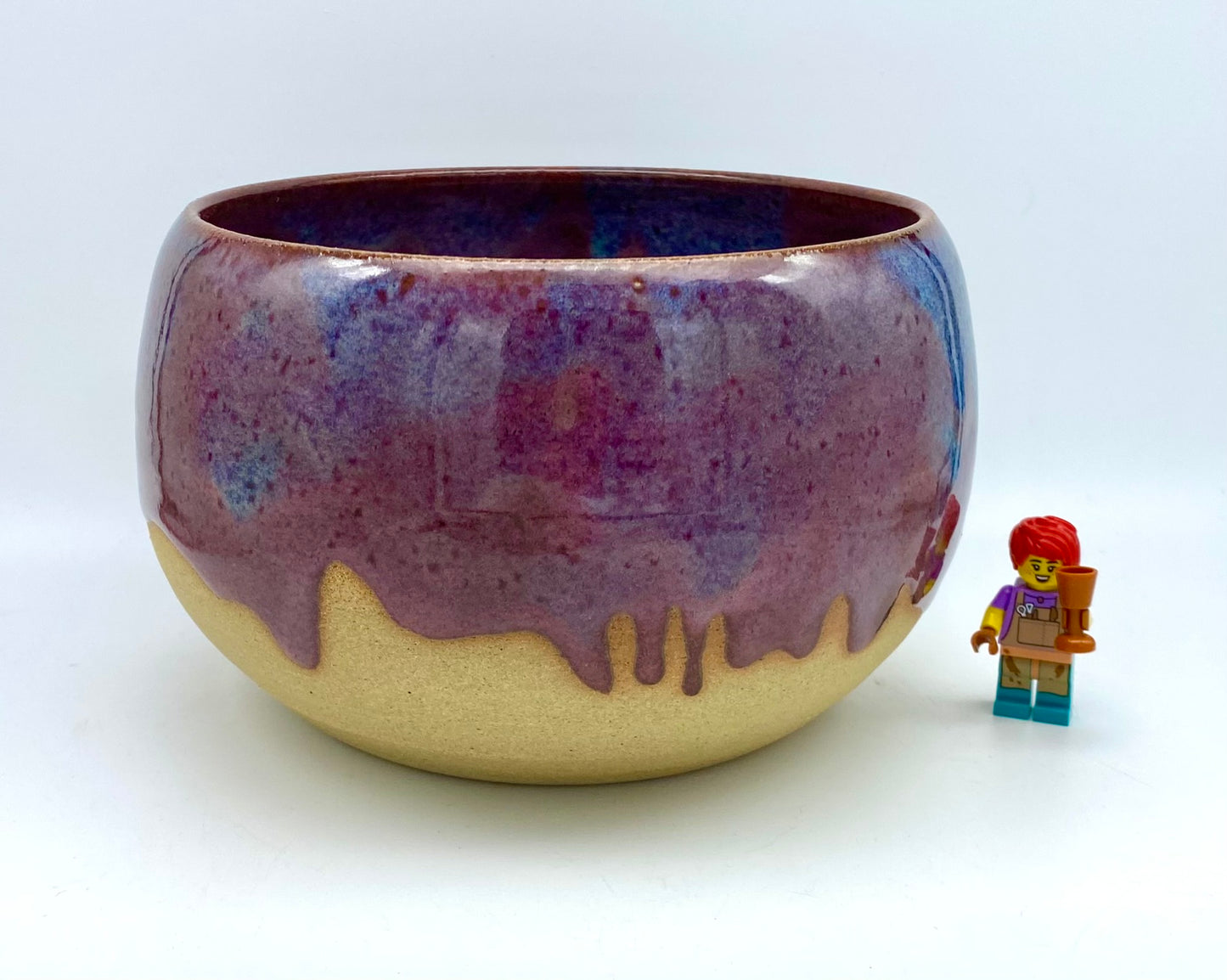 Larger bowl in toasty clay with purple glazes