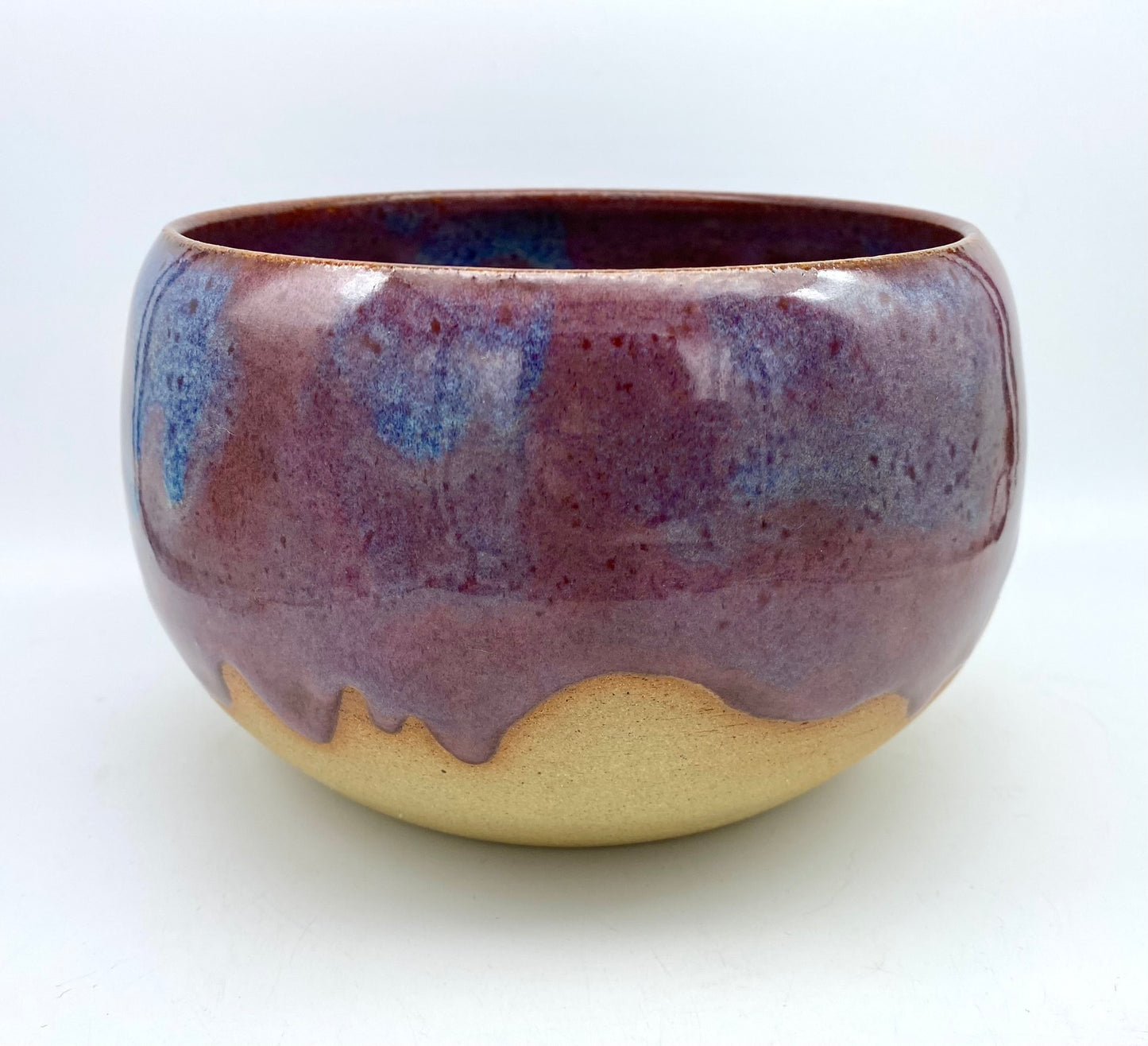 Larger bowl in toasty clay with purple glazes