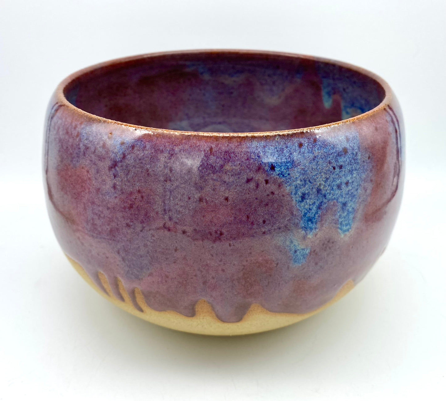 Larger bowl in toasty clay with purple glazes