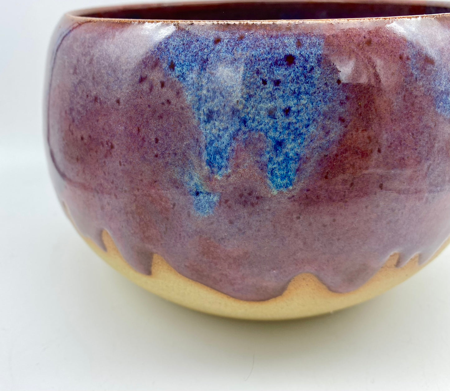 Larger bowl in toasty clay with purple glazes