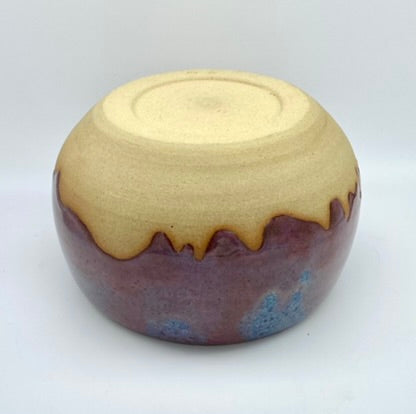 Larger bowl in toasty clay with purple glazes