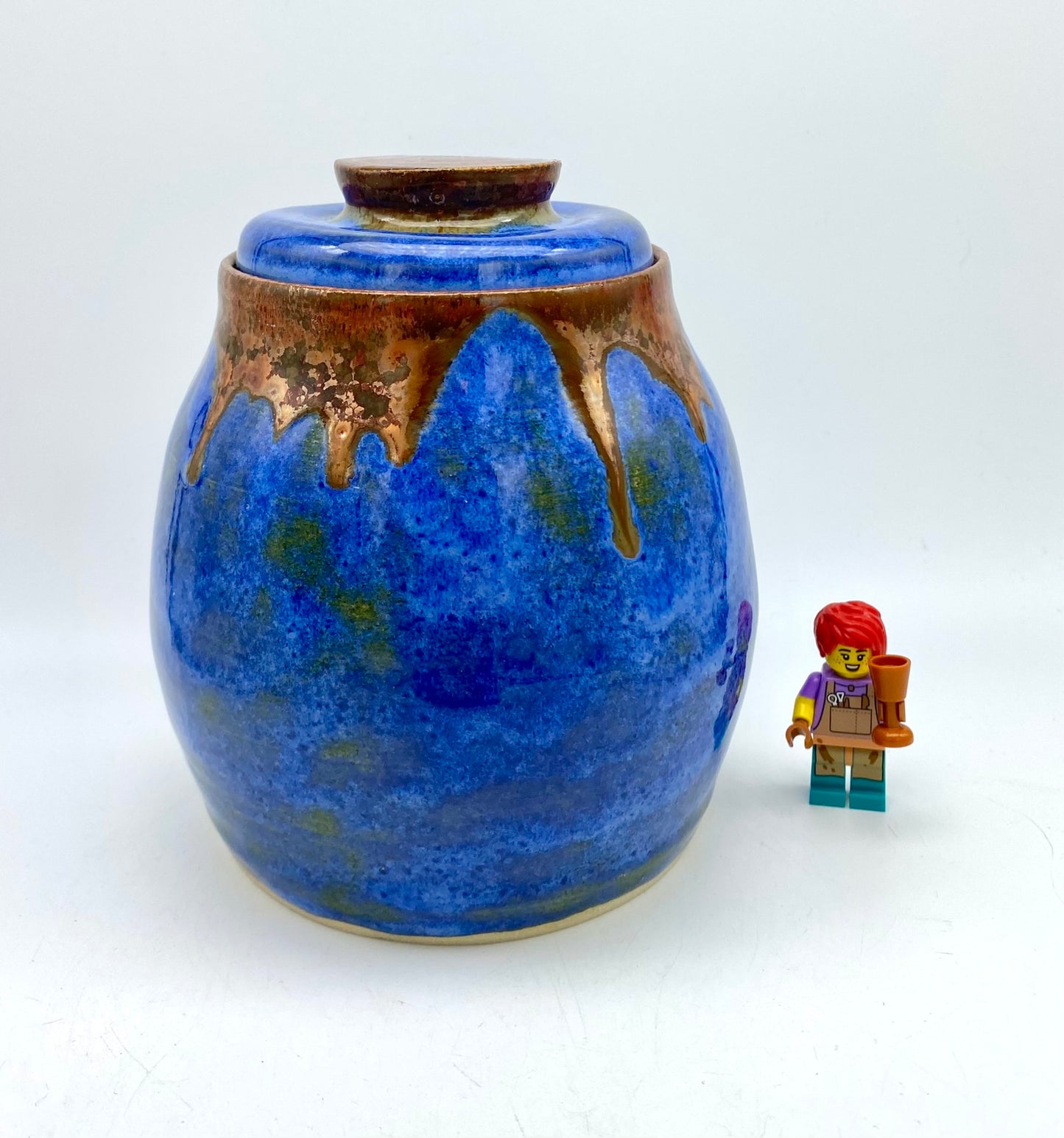 Lidded pot in vibrant blues with copper accents