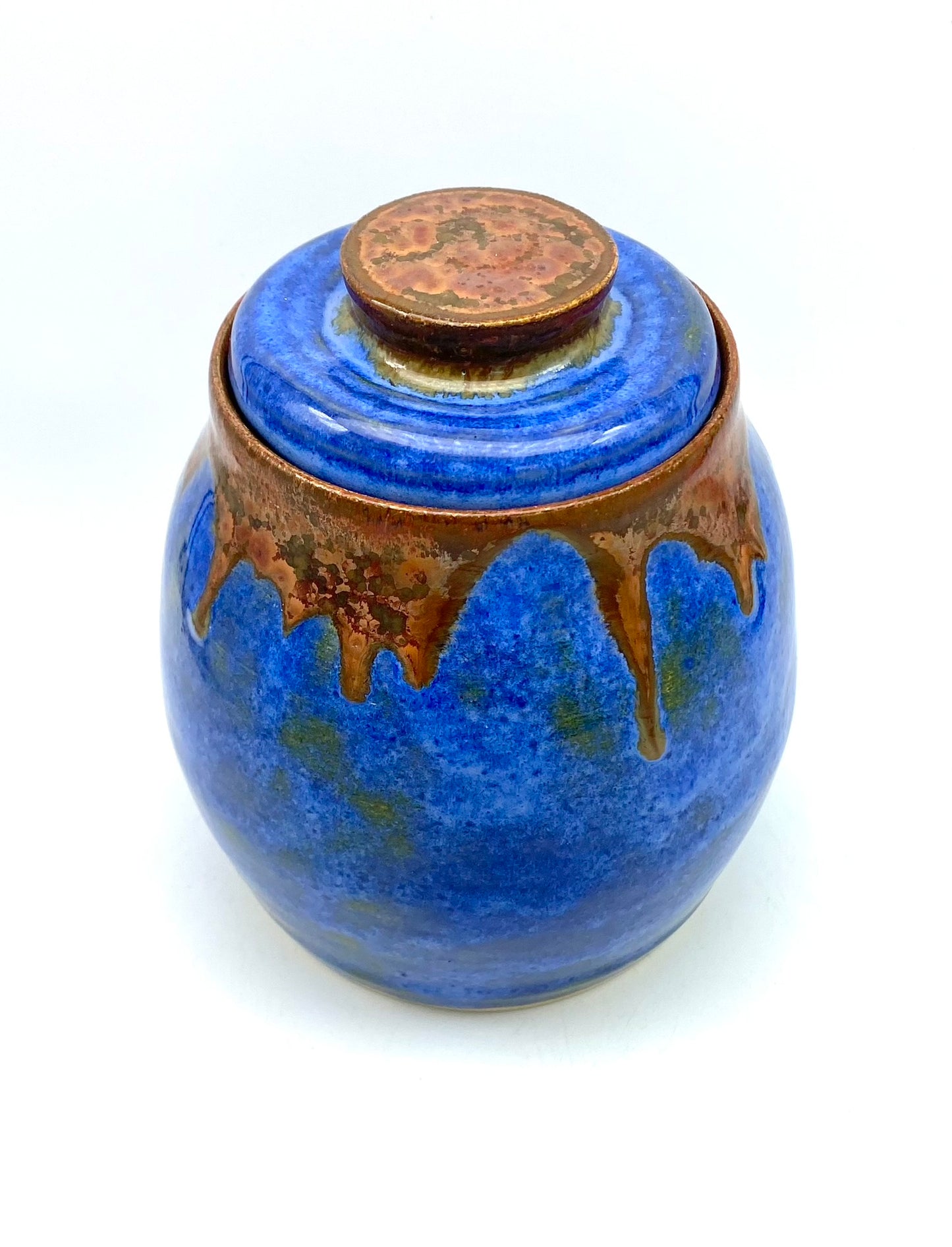 Lidded pot in vibrant blues with copper accents