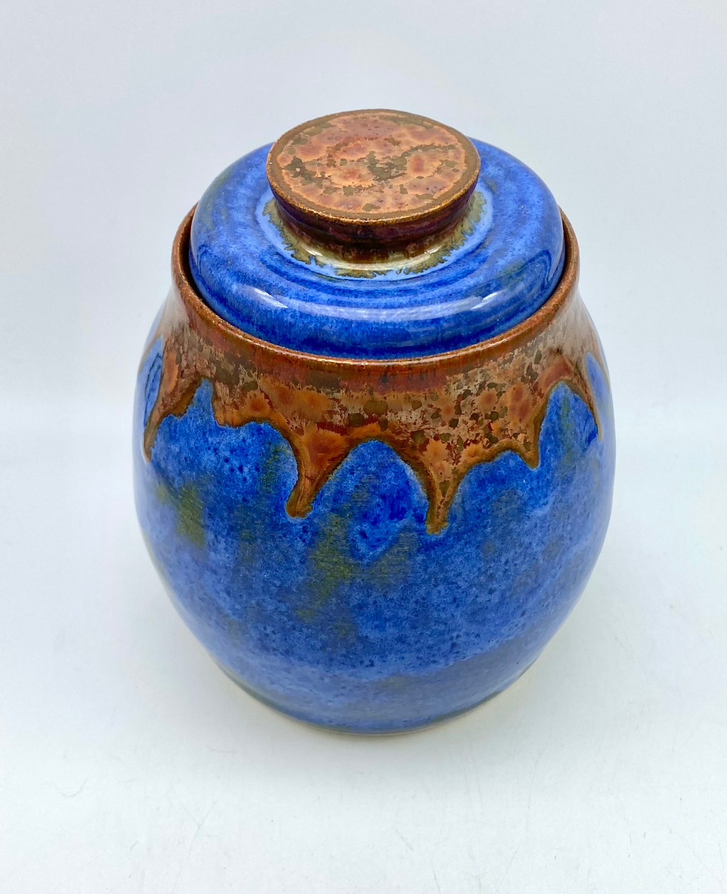 Lidded pot in vibrant blues with copper accents