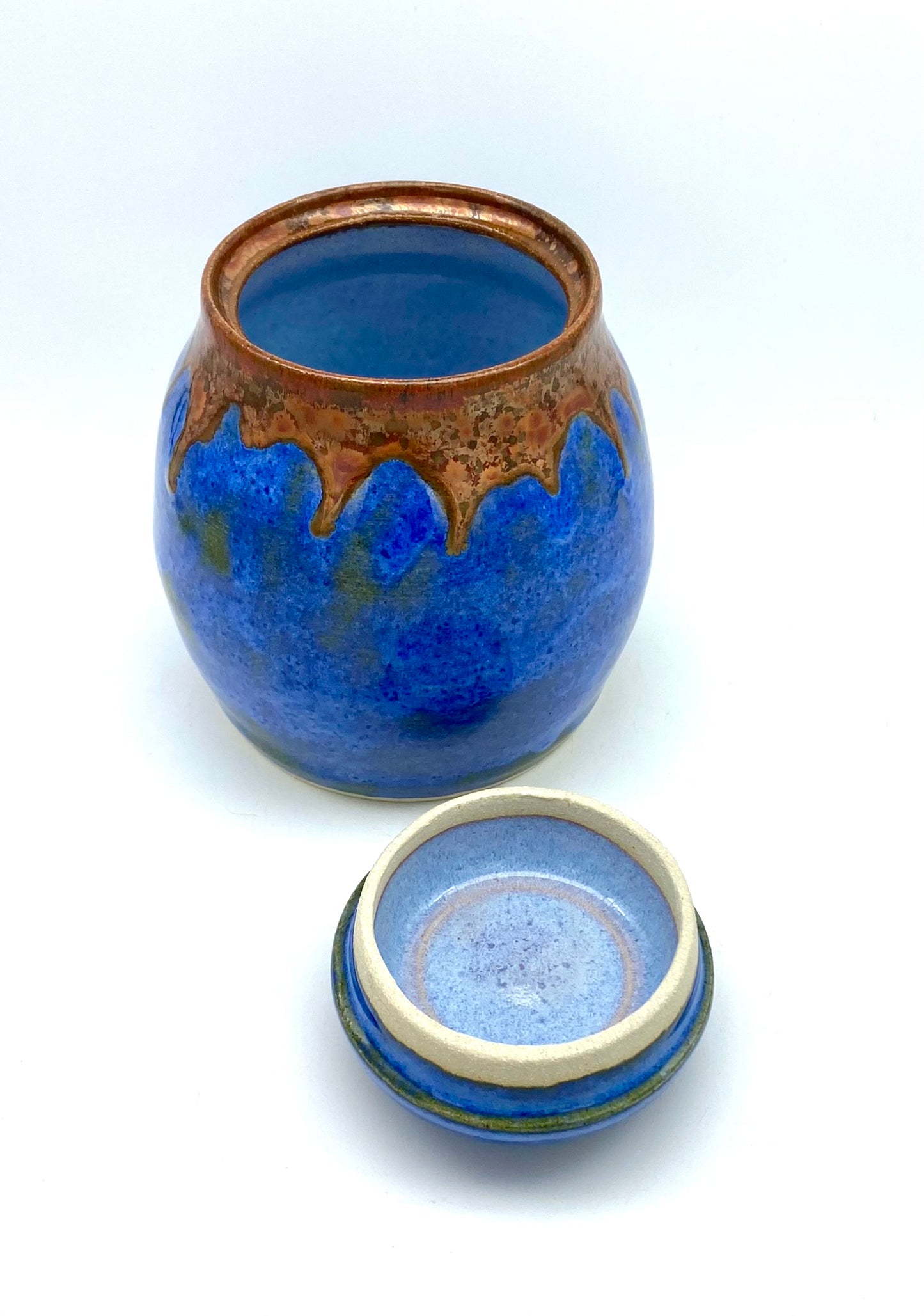 Lidded pot in vibrant blues with copper accents