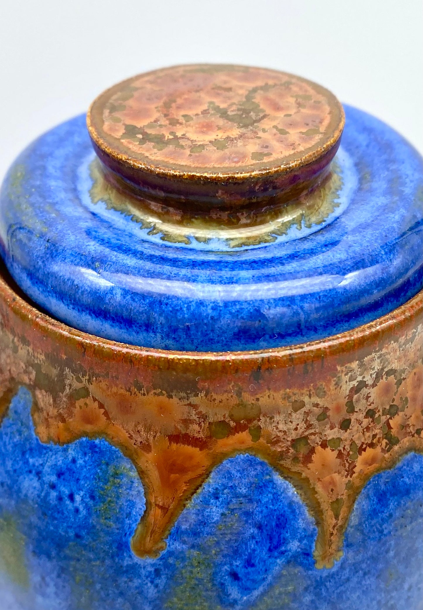 Lidded pot in vibrant blues with copper accents