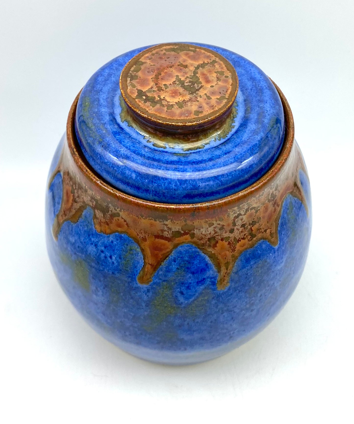 Lidded pot in vibrant blues with copper accents