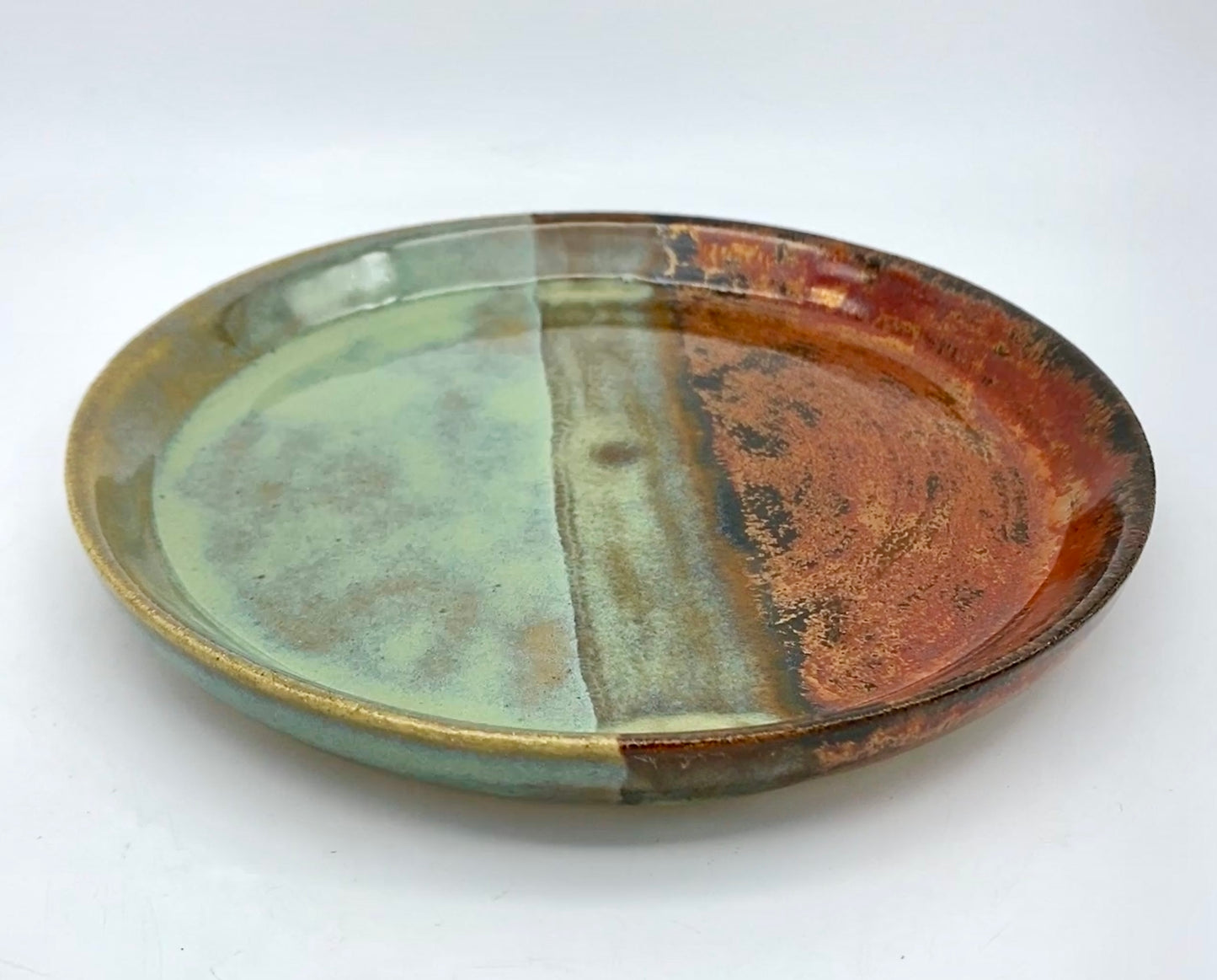 Side plate in greens and shiny copper