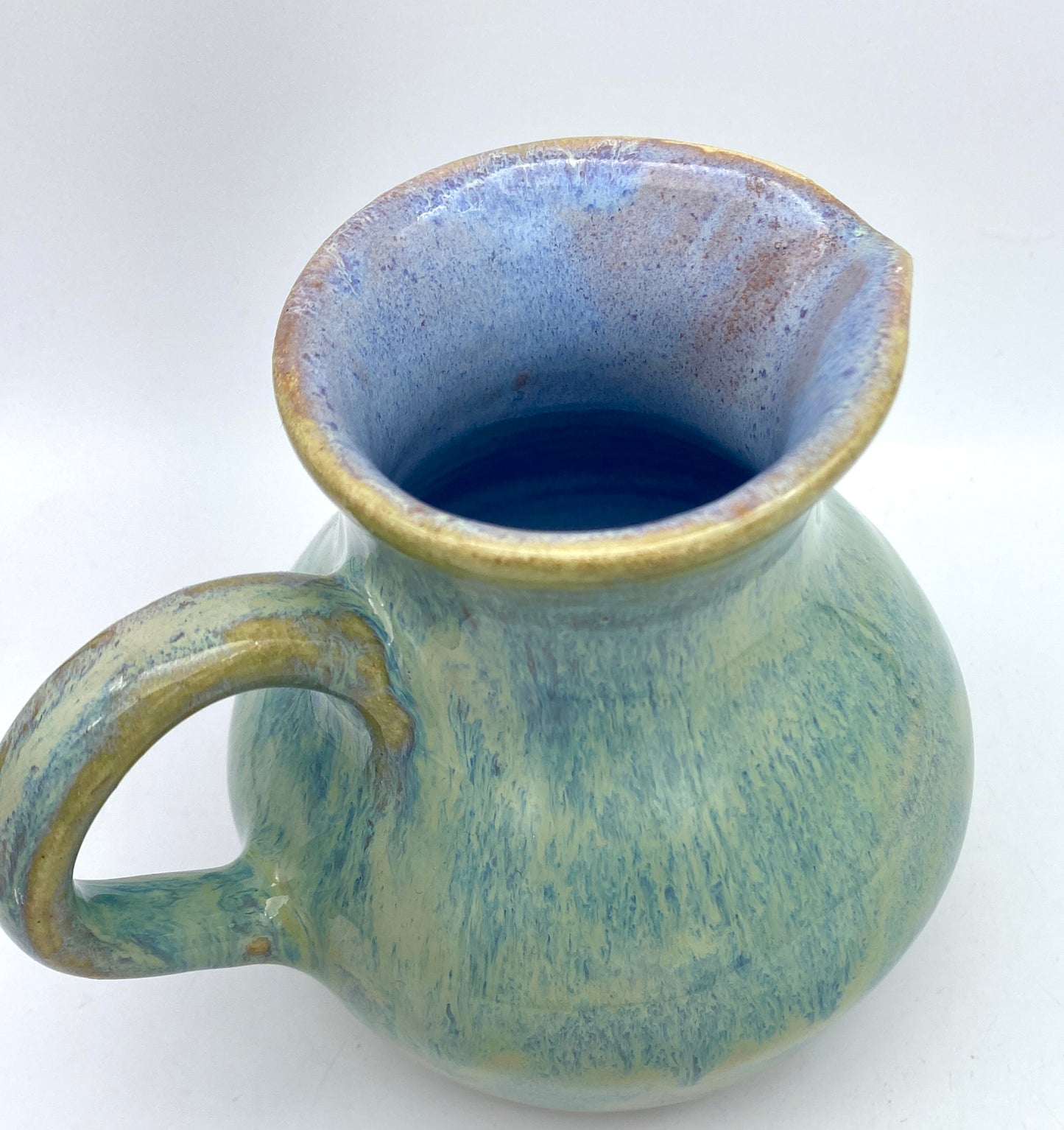 Curvy jug in pastel greens, blues, lavenders