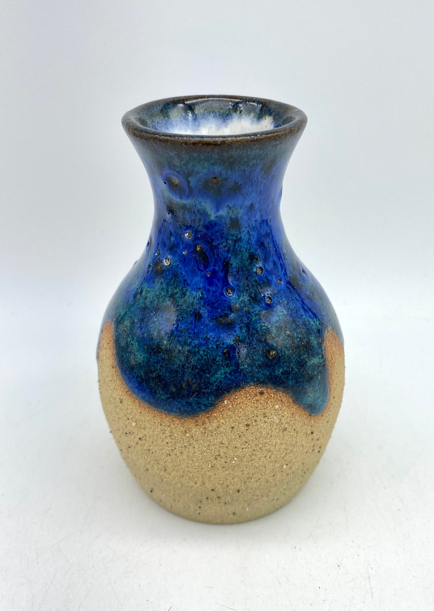 Teeny vase in rich blues and speckled clay