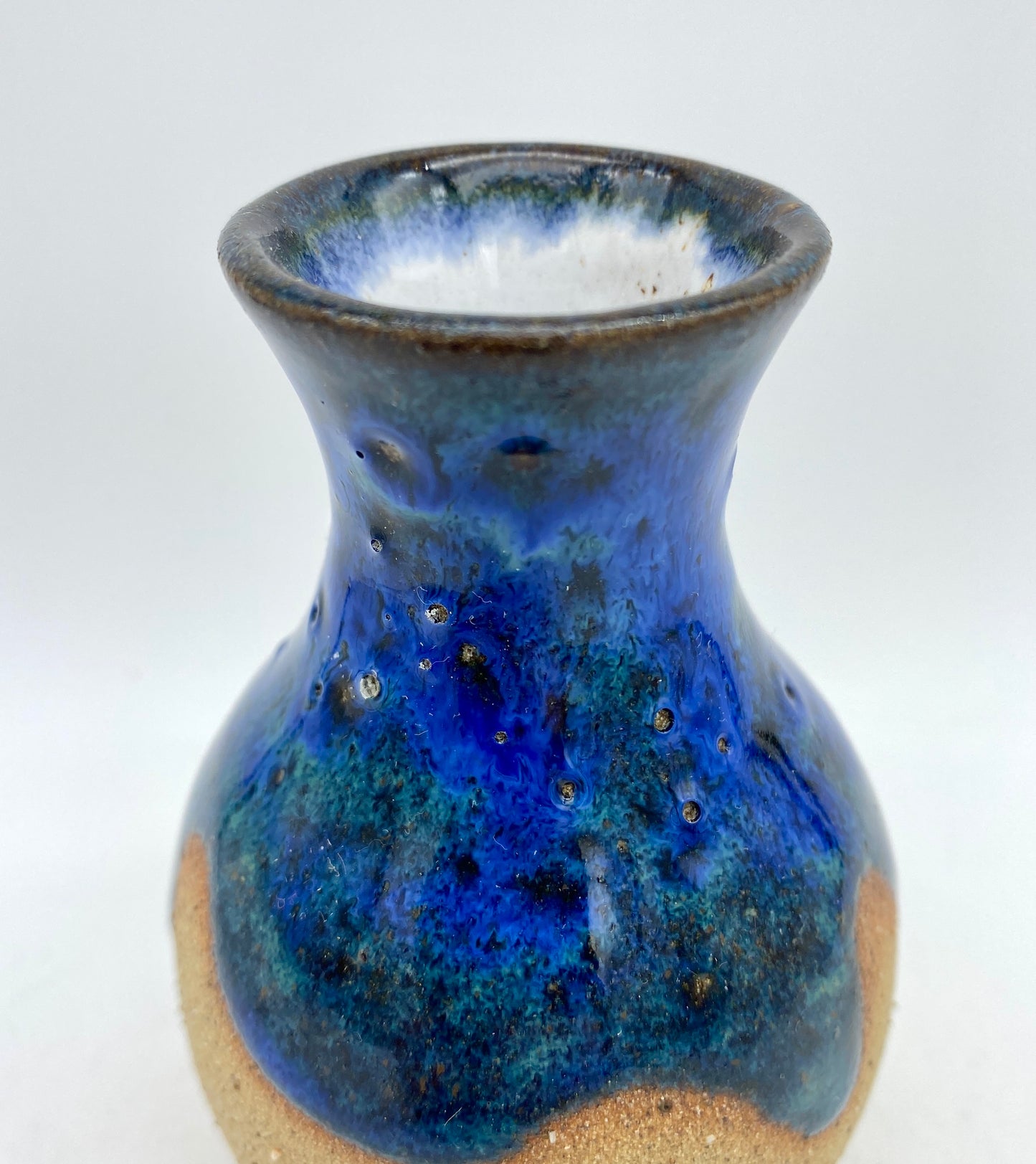 Teeny vase in rich blues and speckled clay